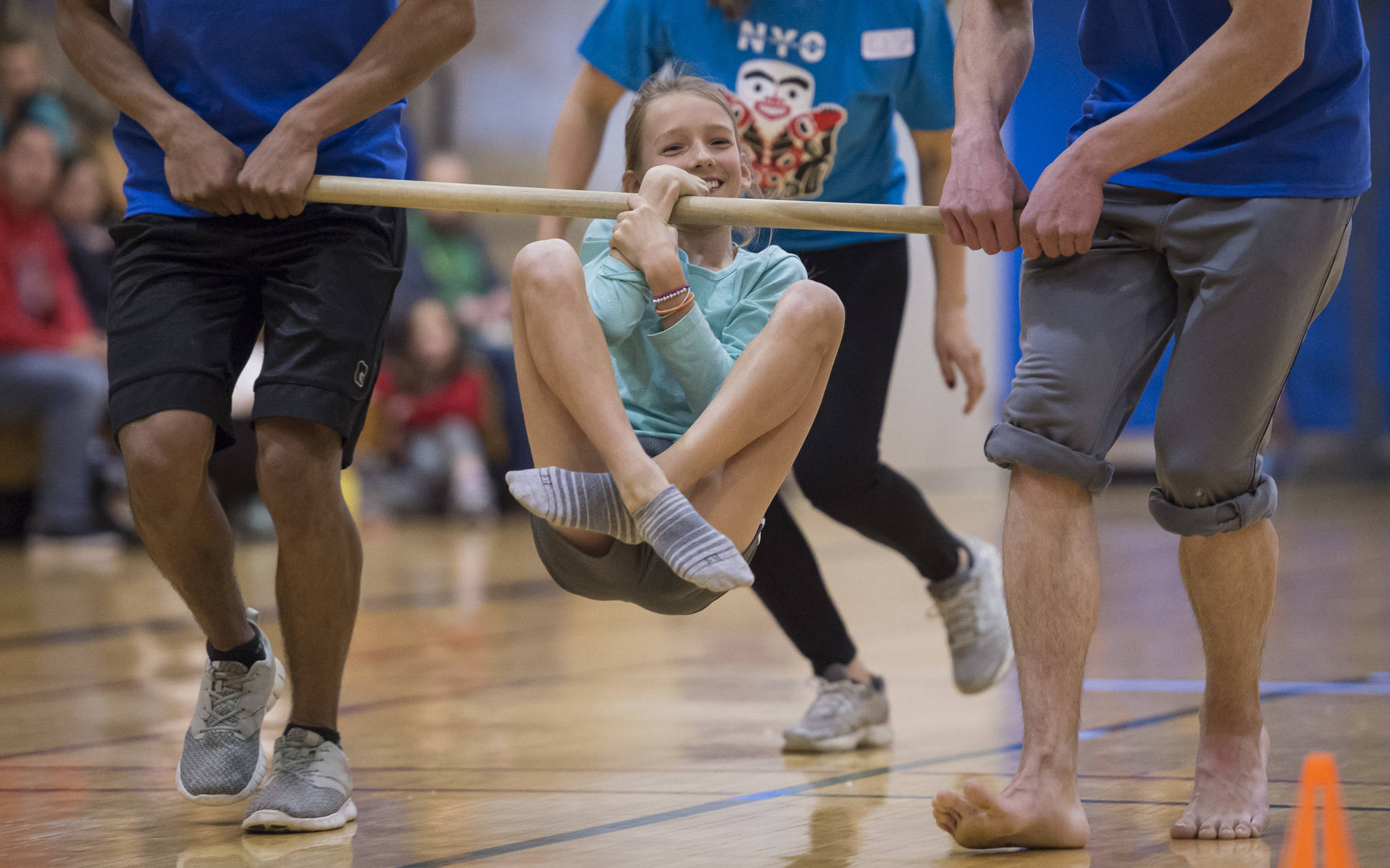 Rayna Tuckwood, 11, participates in the wrist carry at the Native Youth Olympics 2018 Traditional Games at the University of Alaska Southeast Recreational Center on Friday, March 30, 2018. Tuckwood won the event for middle school students. (Michael Penn | Juneau Empire)