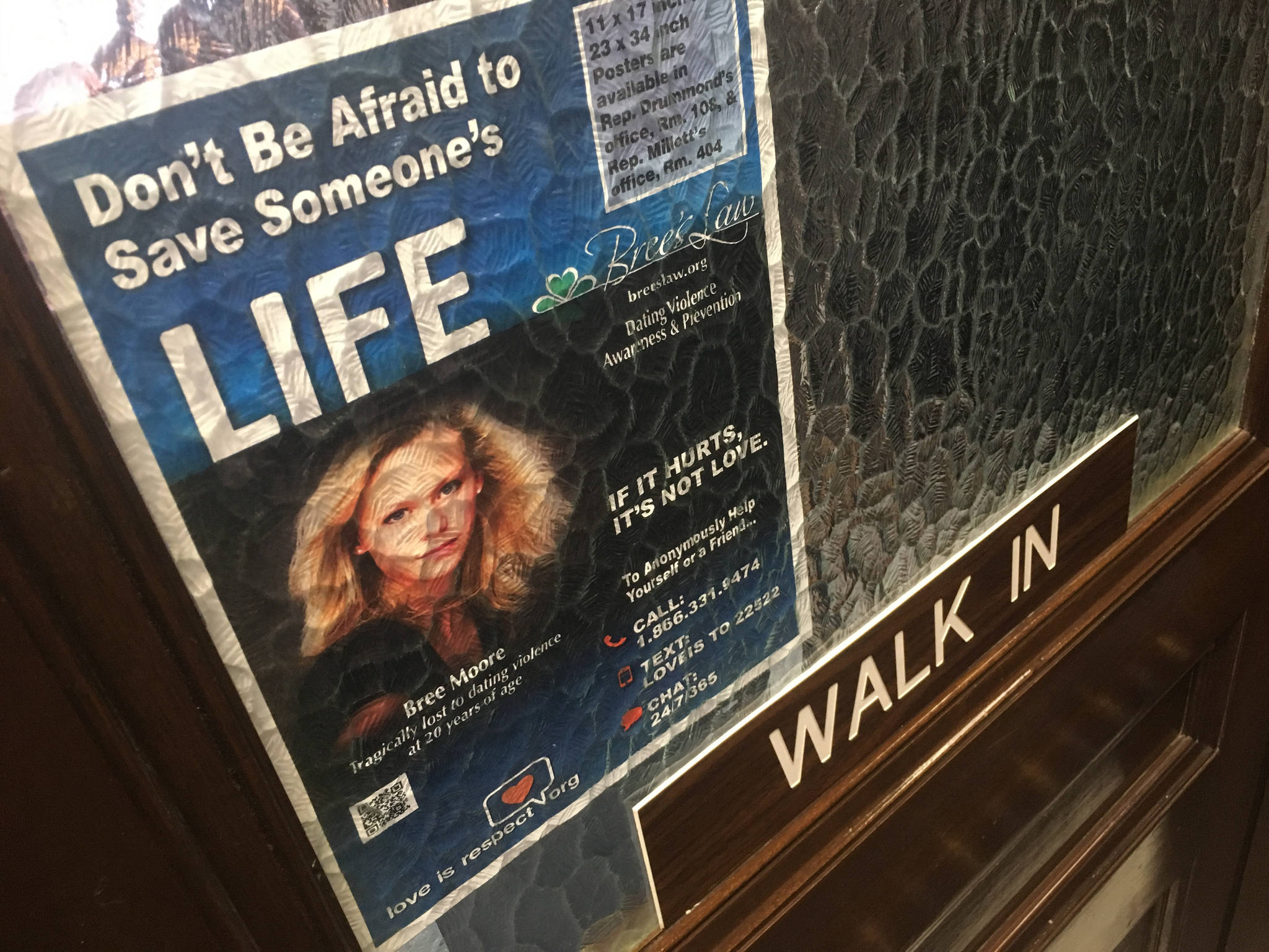 A poster featuring Bree Moore and encouraging action against dating violence is seen on the Alaska State Capitol office door of Rep. Harriet Drummond, D-Anchorage, on April 5, 2018. (James Brooks | Juneau Empire)