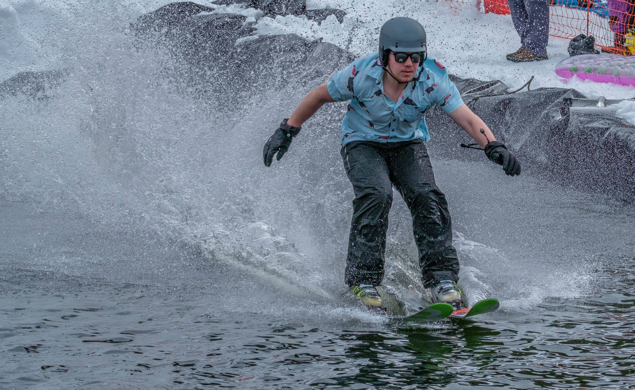 A slush cup participant skims across the water at the 2017 Eaglecrest Slush Cup. The ski area is not hosting the event this year, citing low snow levels. (Lance Nesbitt | For the Juneau Empire)