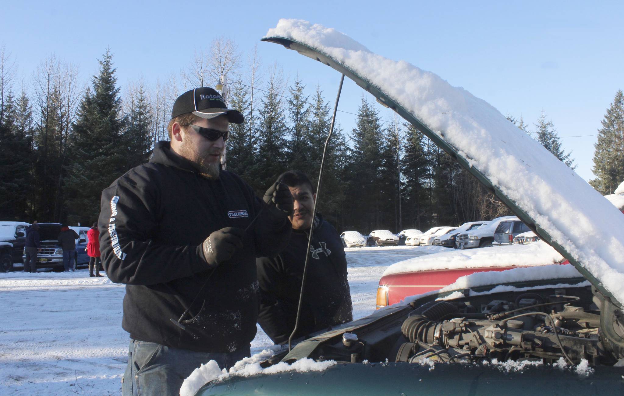 Cody Wilkie, left, and Robert Beltz examine a Ford Ranger at the open viewing of the Juneau Police Department’s impounded vehicles on Wednesday, Nov. 15, 2017. (Alex McCarthy | Juneau Empire)