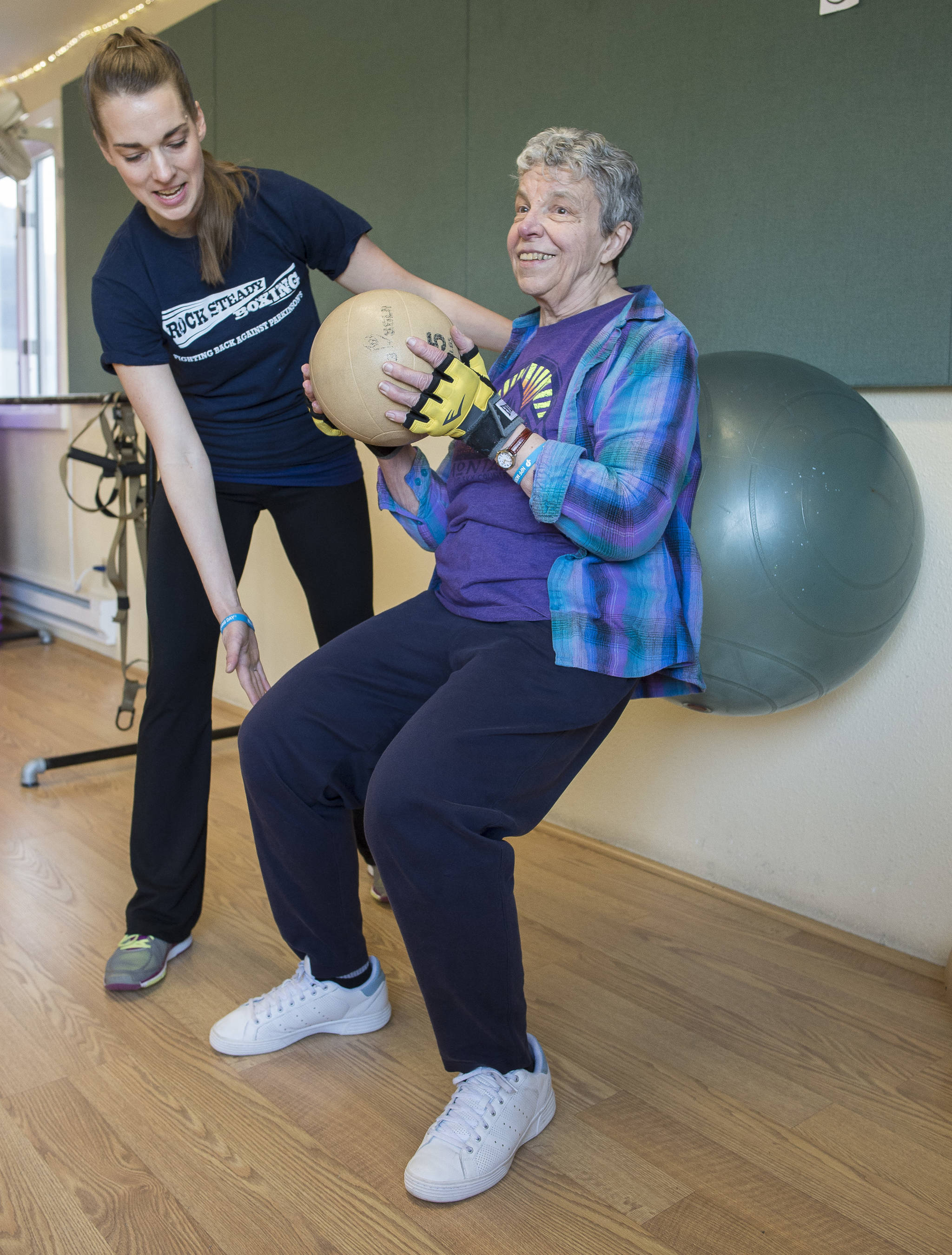 Daisy Davenport, right, works out with the help of coach Keegan Caroll during the Rock Steady workout program to fight against Parkinson’s Disease at Pavitt Health & Fitness on Thursday. Michael Penn | Juneau Empire