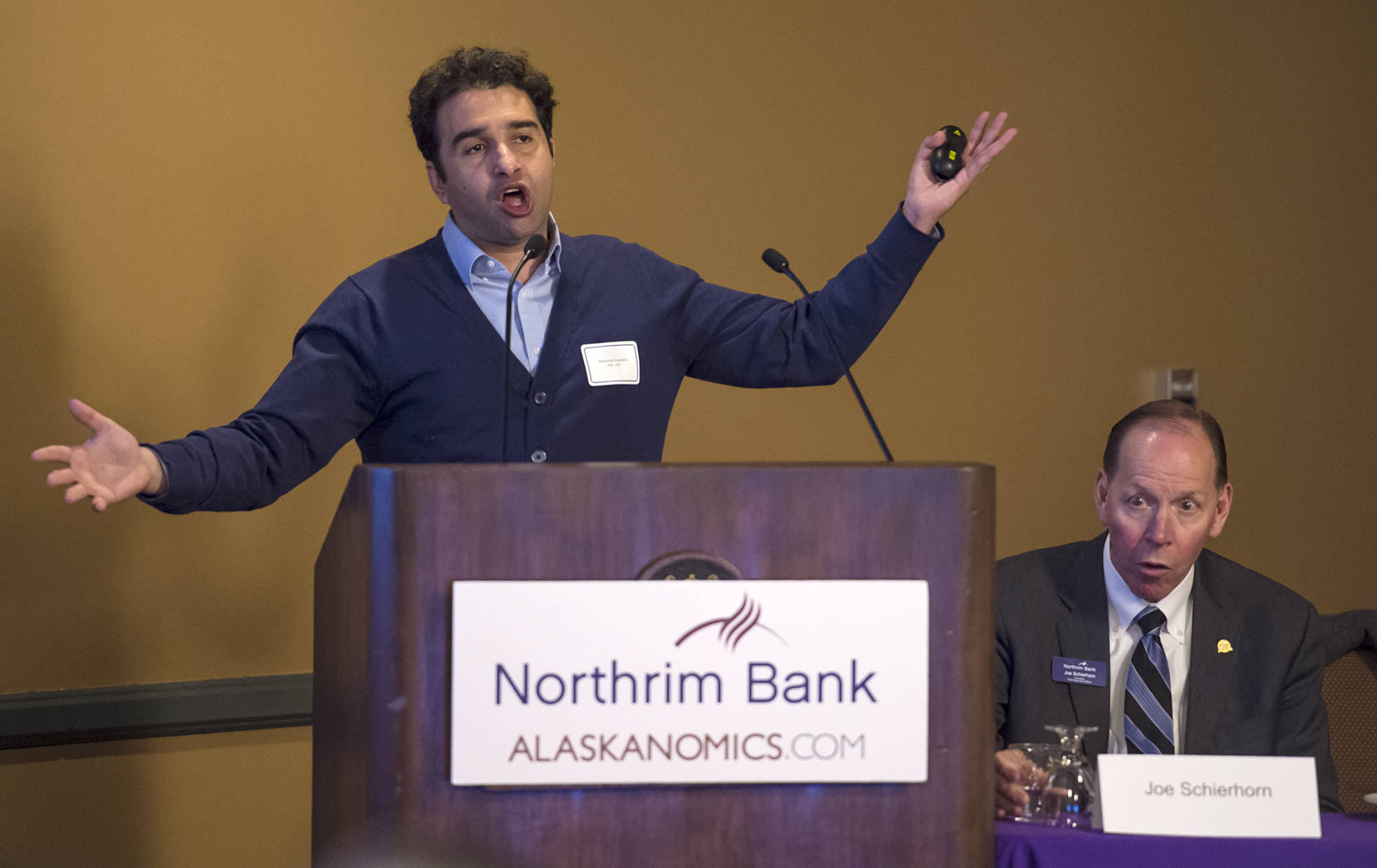 Mouhcine Guettabi, Assistant Professor of Economics at the University of Alaska, speaks at the Northrim Bank Economic Summit at the Baranof Hotel on Wednesday, April 11, 2018. Joe Schierhorn, right, is President and CEO of Northrim Bank Corp. (Michael Penn | Juneau Empire)