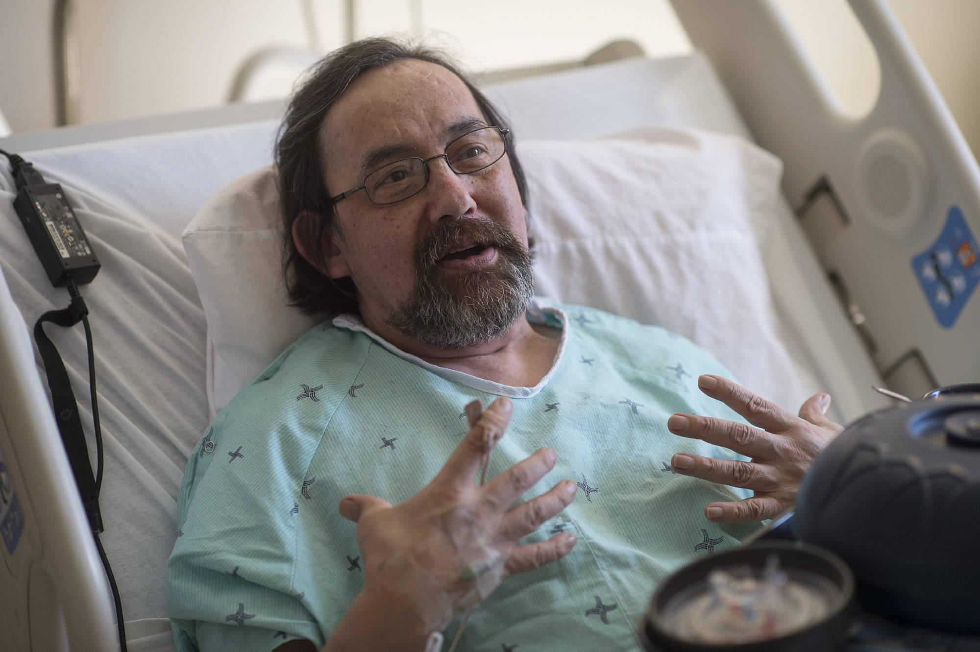 Michael Patterson, the self-proclaimed “Ghostwalker” of Juneau, speaks from a bed at Bartlett Regional Hospital on Wednesday, April 11, 2018. Patterson, a spokesperson for the Center for Disease Control’s anti-smoking campaign, is diagnosed with Chronic Obstructive Pulmonary Disorder, a form of emphysema. Patterson said exposure to black mold sent him to the hospital with symptoms like pneumonia. (Michael Penn | Juneau Empire)