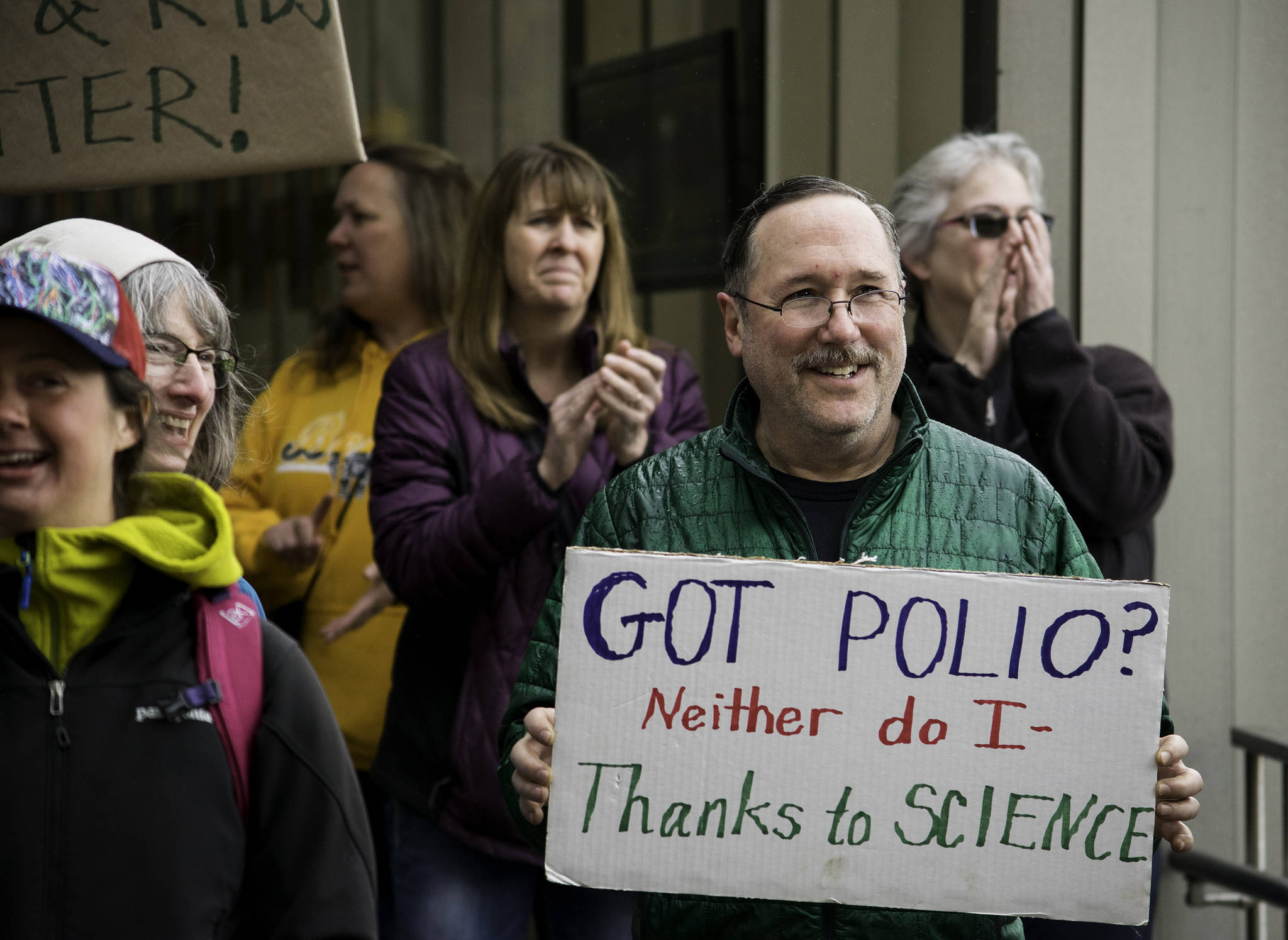 Guy Archibald assures those around him that he is Polio-free — thanks to vaccination — during the March for Science at the Alaska Capitol on Saturday, April 14, 2018. (Richard McGrail | Juneau Empire)