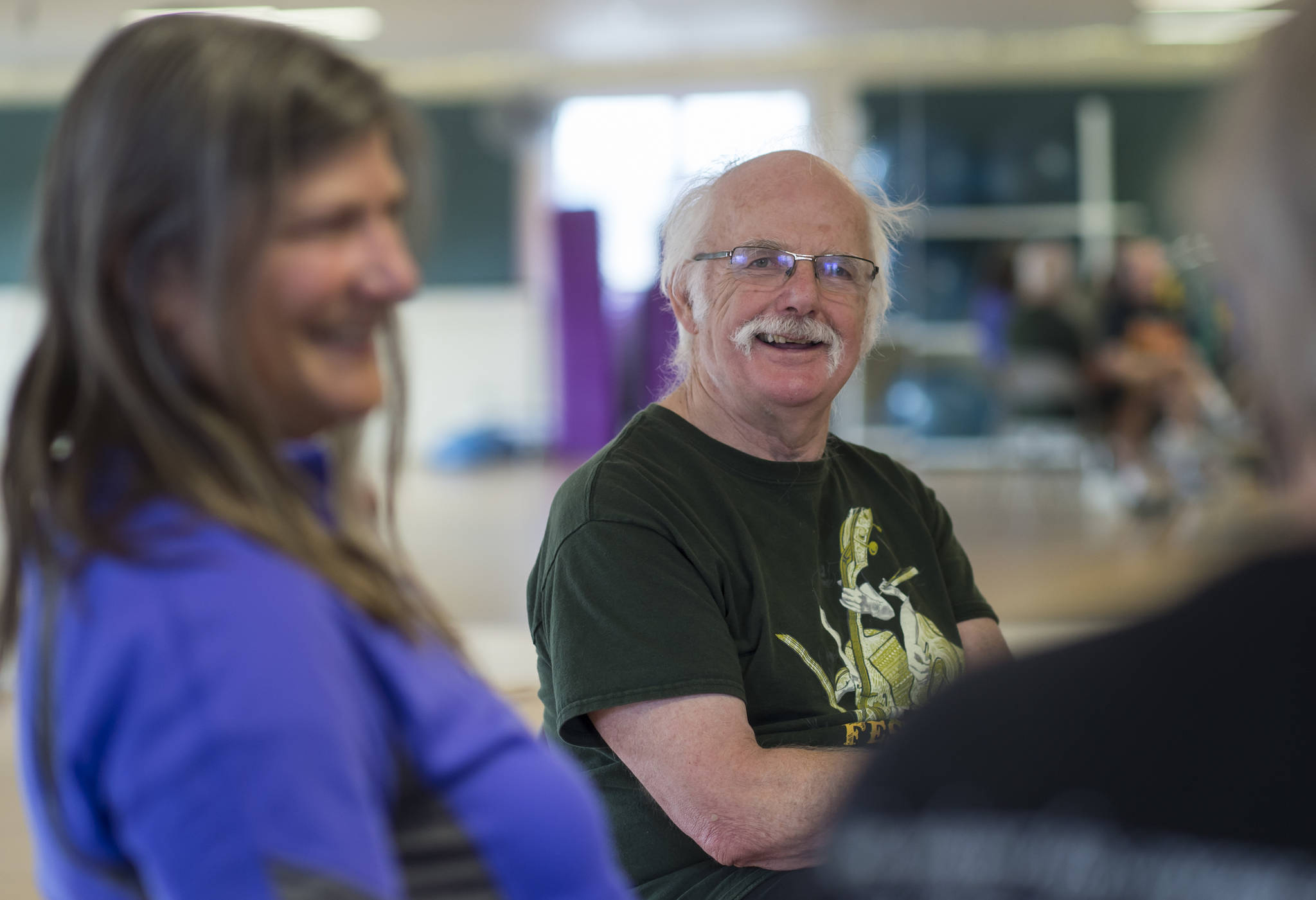 Steve Wolf and his wife, Bev, left, talk with another couple after attending the Rock Steady Boxing Class at Pavitt Health & Fitness on Thursday, April 12, 2018. (Michael Penn | Juneau Empire)