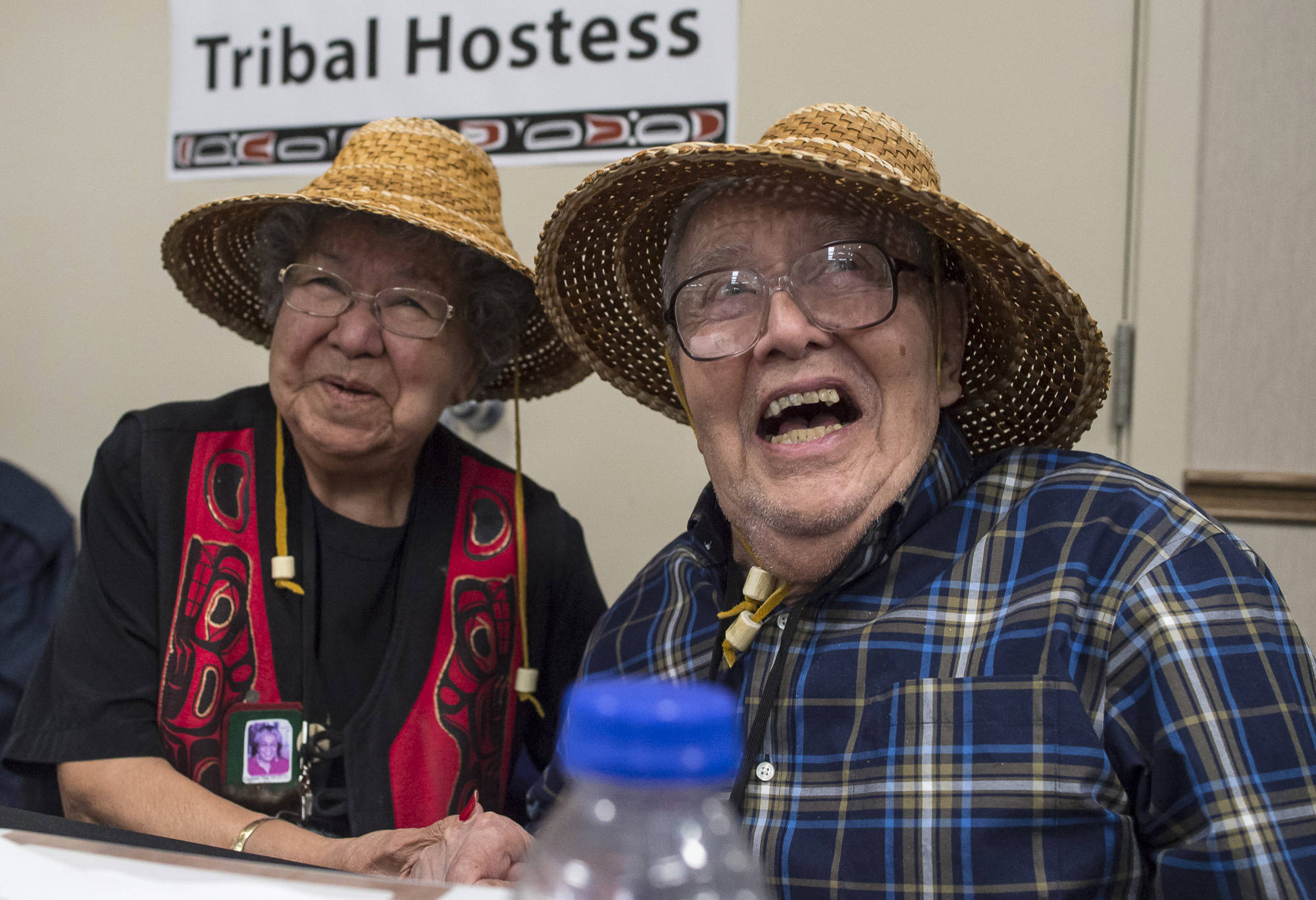 Tribal Hostess Bertha Karras, of Sitka, left, and Tribal Host Fred Hamilton Sr., of Craig, share a laugh at the 83rd Annual Tribal Assembly of the Central Council of the Tlingit and Haida Indian Tribes of Alaska at Elizabeth Peratrovich Hall on Wednesday, April 18, 2018. (Michael Penn | Juneau Empire)
