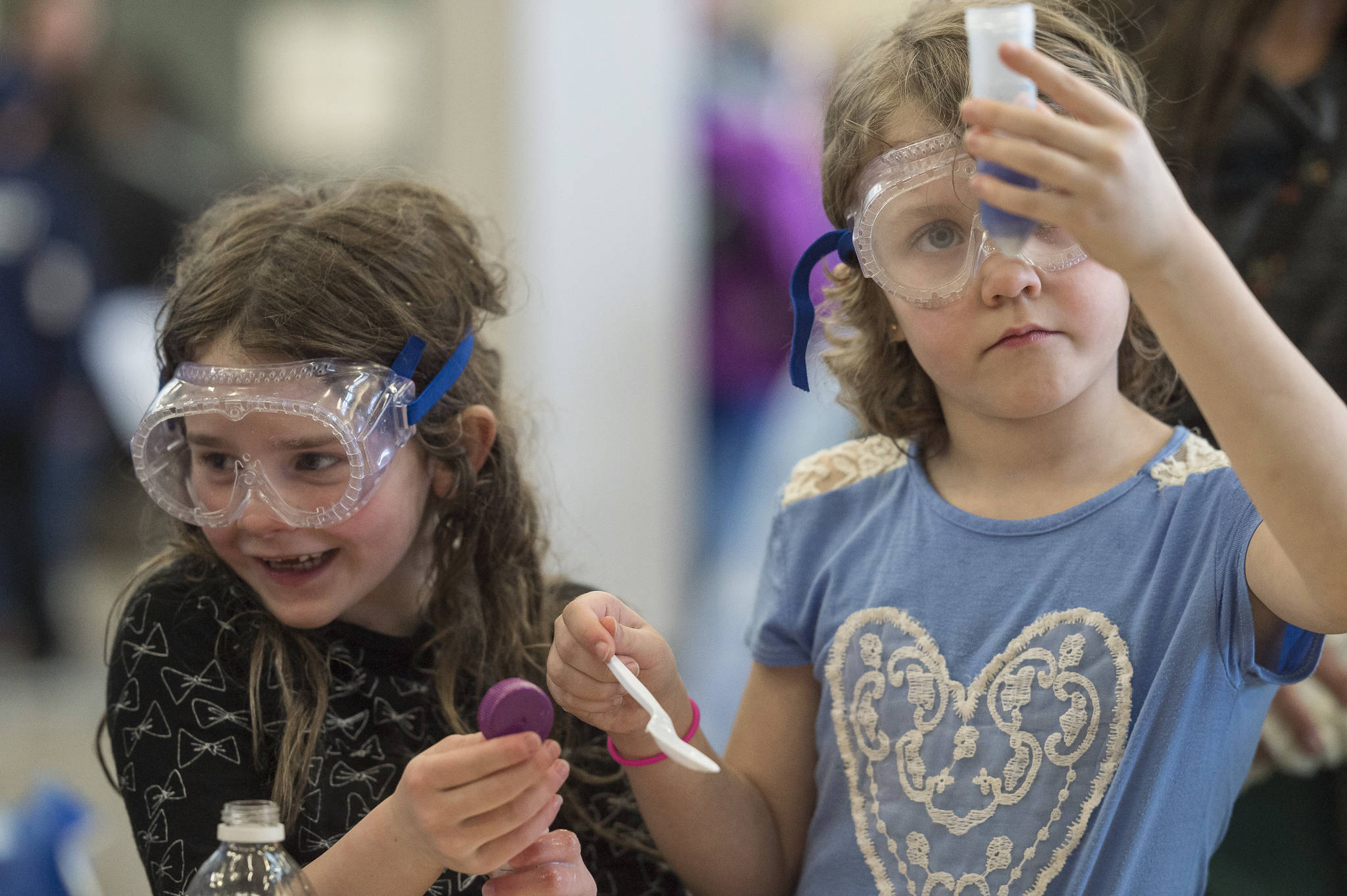 Madeline Branch, 6, left, and Millie Bass, 7, experiment with household products to learn about base and acid on the Ph scale during the Family STEM Night at Thunder Mountain High School on Wednesday, March 28, 2018. STEM Night was organized by Juneau STEM Coalition, Juneau School District Teachers and Juneau public librarians with help from many area organizations and individuals. (Michael Penn | Juneau Empire File)