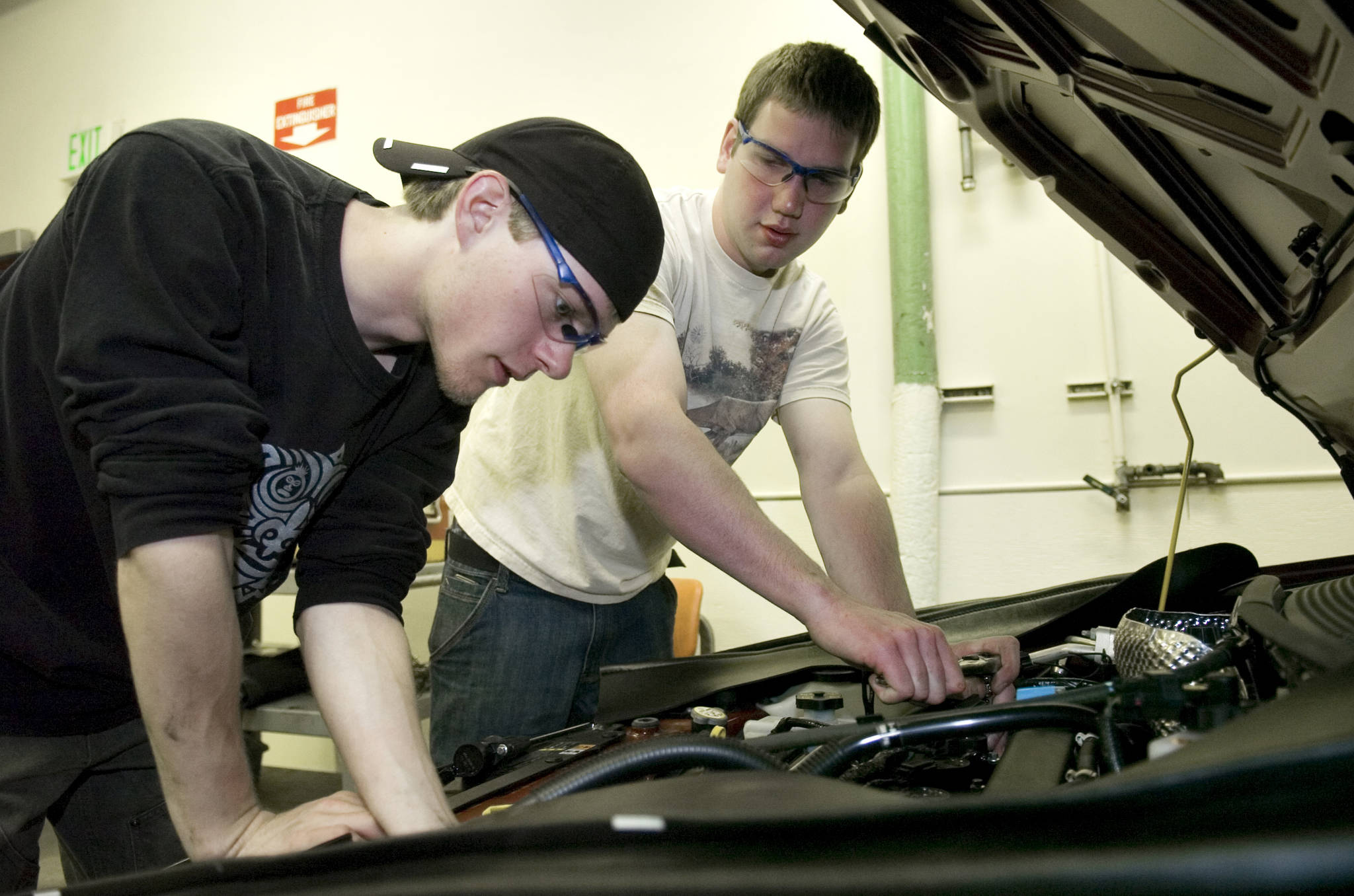 In this May 2009 photo, Josh Smith, left, and Carson Paul, both seniors at Juneau-Douglas High School, work on a car in the school’s auto shop as they practice for a state-wide contest in Anchorage. (Michael Penn | Juneau Empire File)