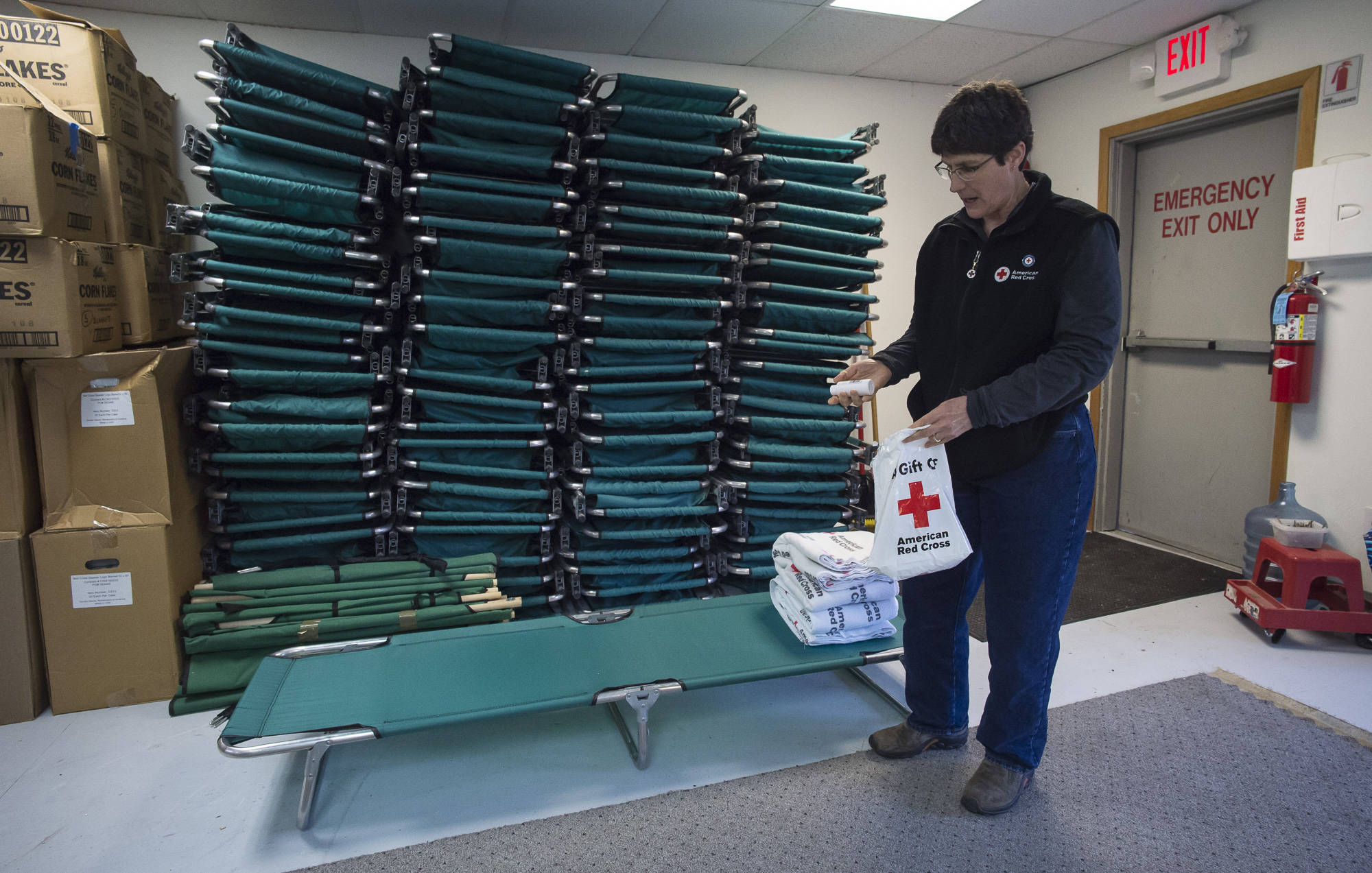 Volunteer Sudie Hargis gives a tour of the supply room during an open house at the new Southeast office of the American Red Cross of Southeast Alaska on Thursday, April 26, 2018. (Michael Penn | Juneau Empire)