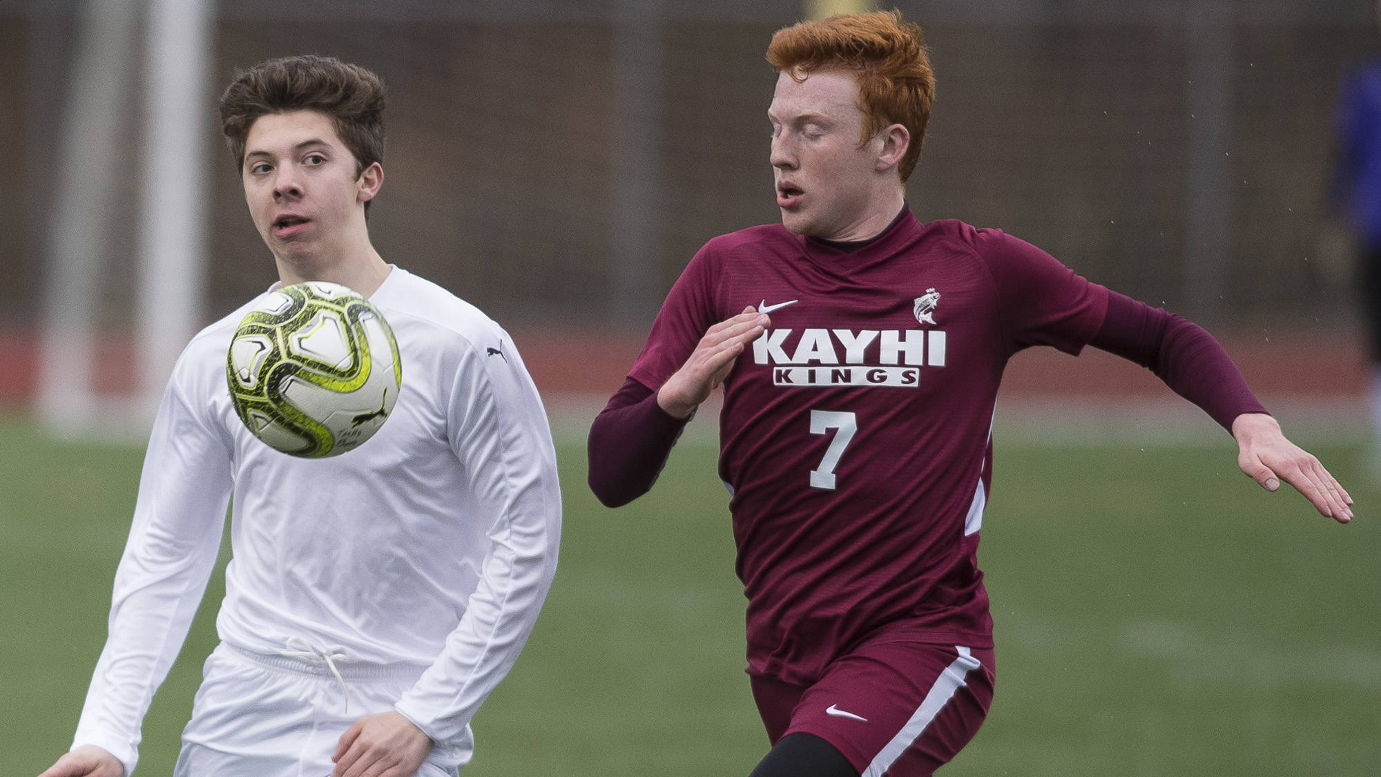 Thunder Mountain’s Jake Babcock, left, drives the ball down field against Ketchikan’s Max Collins at TMHS on Thursday. (Michael Penn | Juneau Empire)