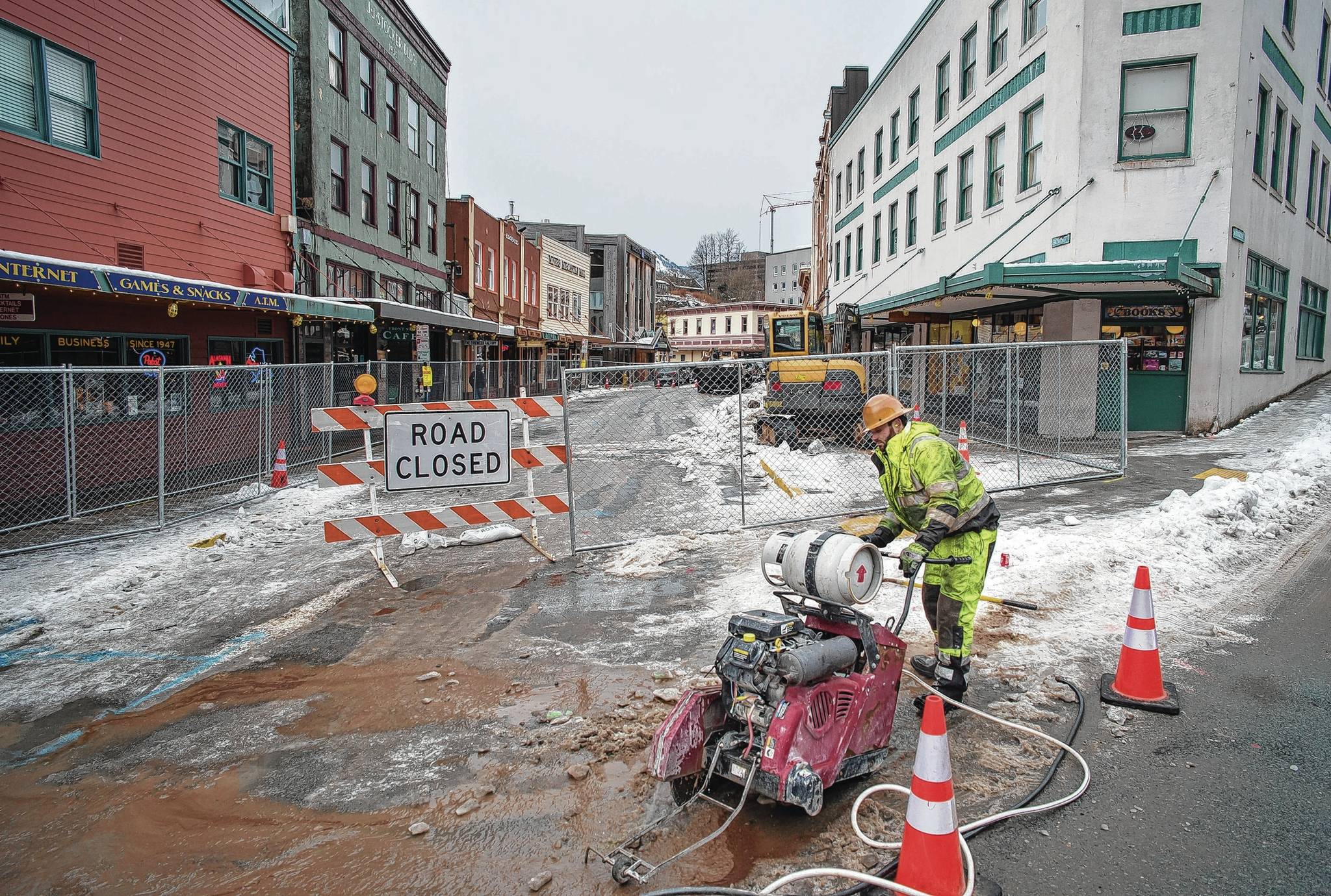 Mariyan Aleksiev, of Earthmovers, cuts into the pavement at the intersection of Franklin and Front Streets on Tuesday, Feb. 20, 2018. (Michael Penn | Juneau Empire File)