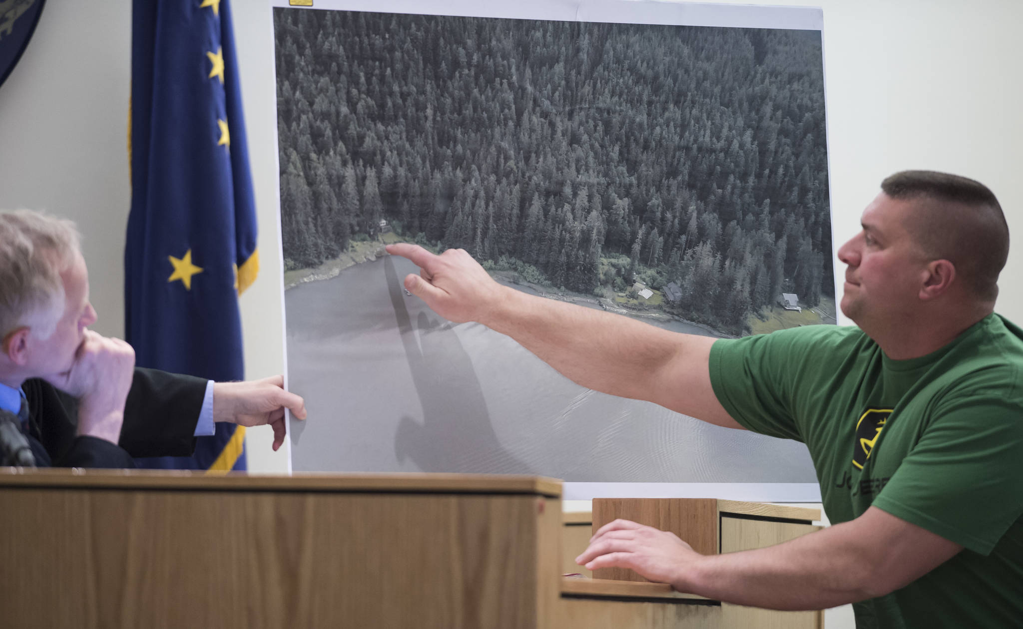 Witness Seth Bradshaw points to where he found the body Duilio Antonio “Tony” Rosales at an Excursion Inlet cabin while Juneau Superior Court Judge Philip Pallenberg holds a map during the trial of Mark De Simone in Juneau Superior Court on Monday, April 30, 2018. De Simone is accused of killing Rosales during a hunting trip in Excursion Inlet in 2016. Bradshaw was the first person to find Rosales. (Michael Penn | Juneau Empire)