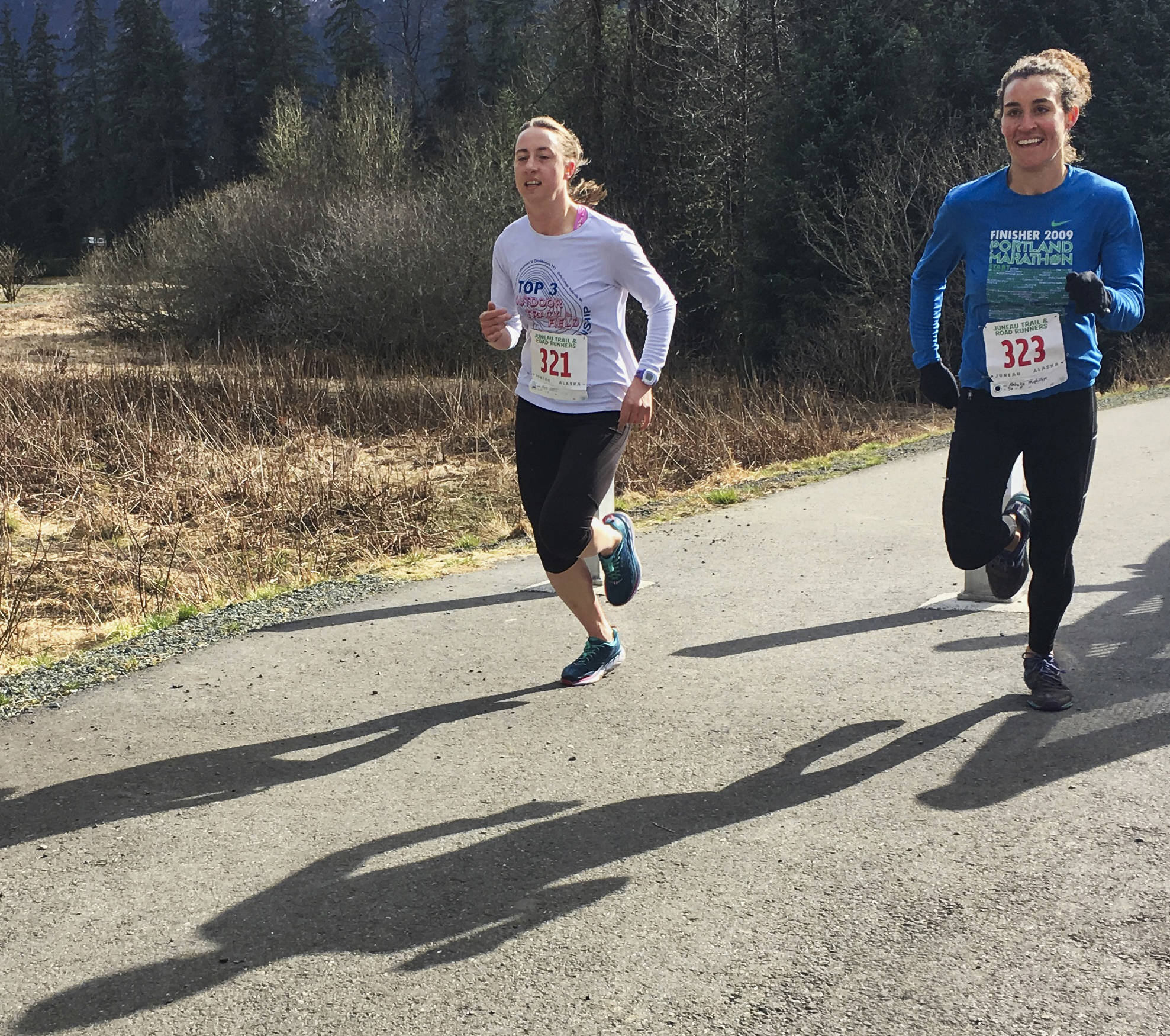 Beth Gollin and Natalie McPhillips race in the Pavitt Health and Fitness 7K on Saturday at the Brotherhood Bridge Parking Lot. (Courtesy Photo | Linda Kruger)