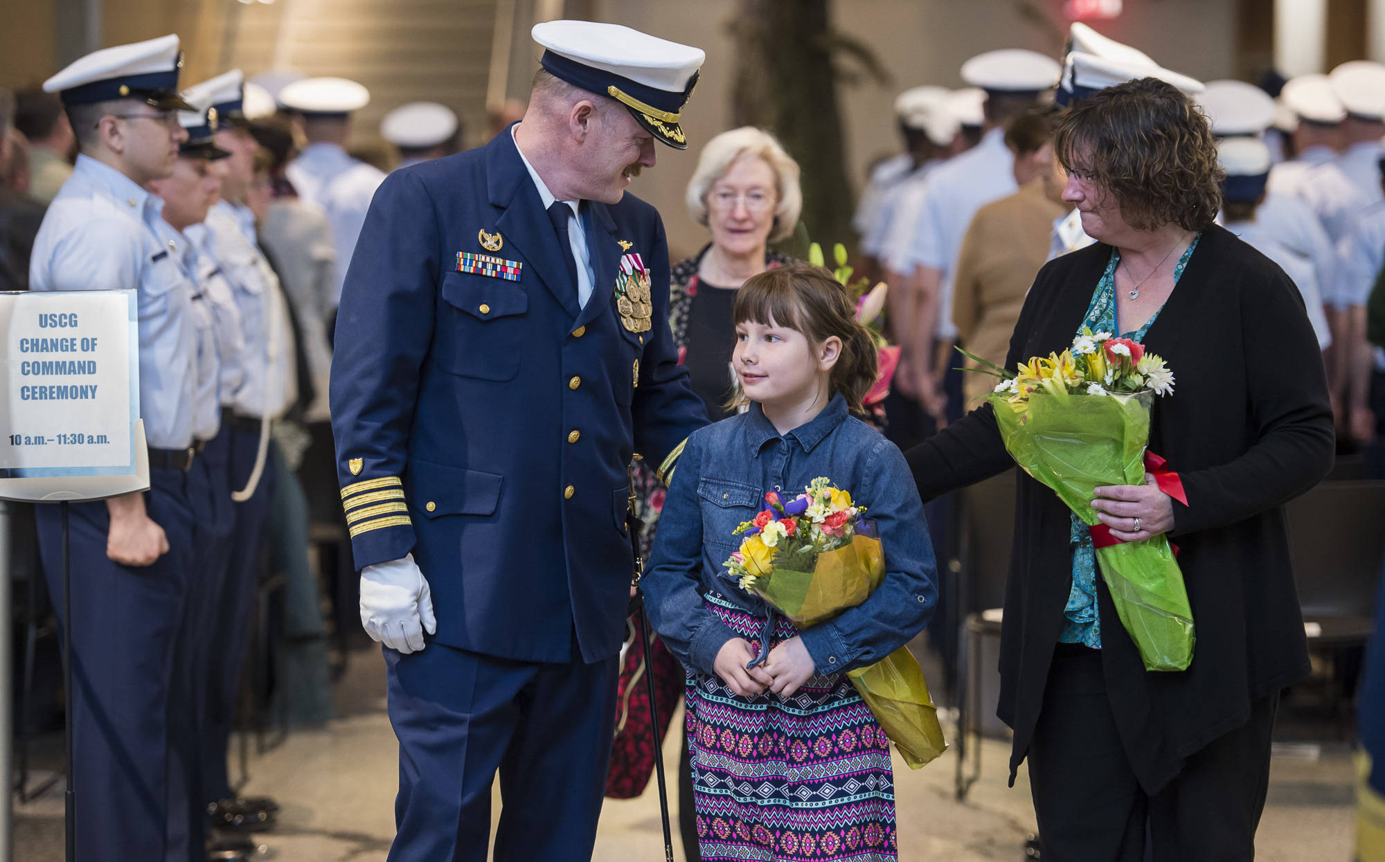 Capt. Phillip Thorne, outgoing Commander of Coast Guard Sector Juneau, walks with his wife, Jennifer, daughter, Madeline, 8, and mother, Gloria Thorne, at the conclusion of his Change of Command and Retirement Ceremonies at the Alaska State Museum on Friday, May 4, 2018. (Michael Penn | Juneau Empire)