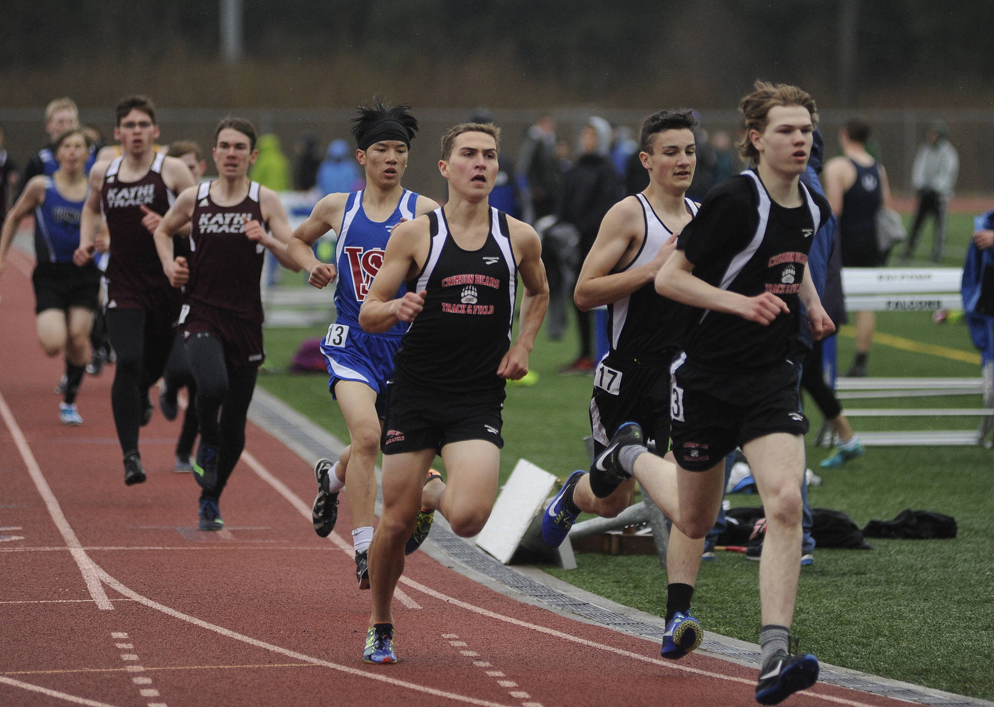 Juneau-Douglas High School senior Tim McKenna, third from right, and junior Dalton Hoy, far right, round the second turn in the 800-meter run on Friday at the Capital Invitational track and field meet at TMHS. (Richard McGrail | Juneau Empire)