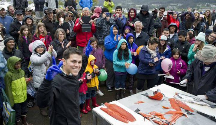 Irat De La Mora acknowledges the crowd after showing his talent for slicing up coho salmon at the Juneau Maritime Festival at Marine Park on Saturday, May 7, 2016. (Michael Penn | Juneau Empire File)