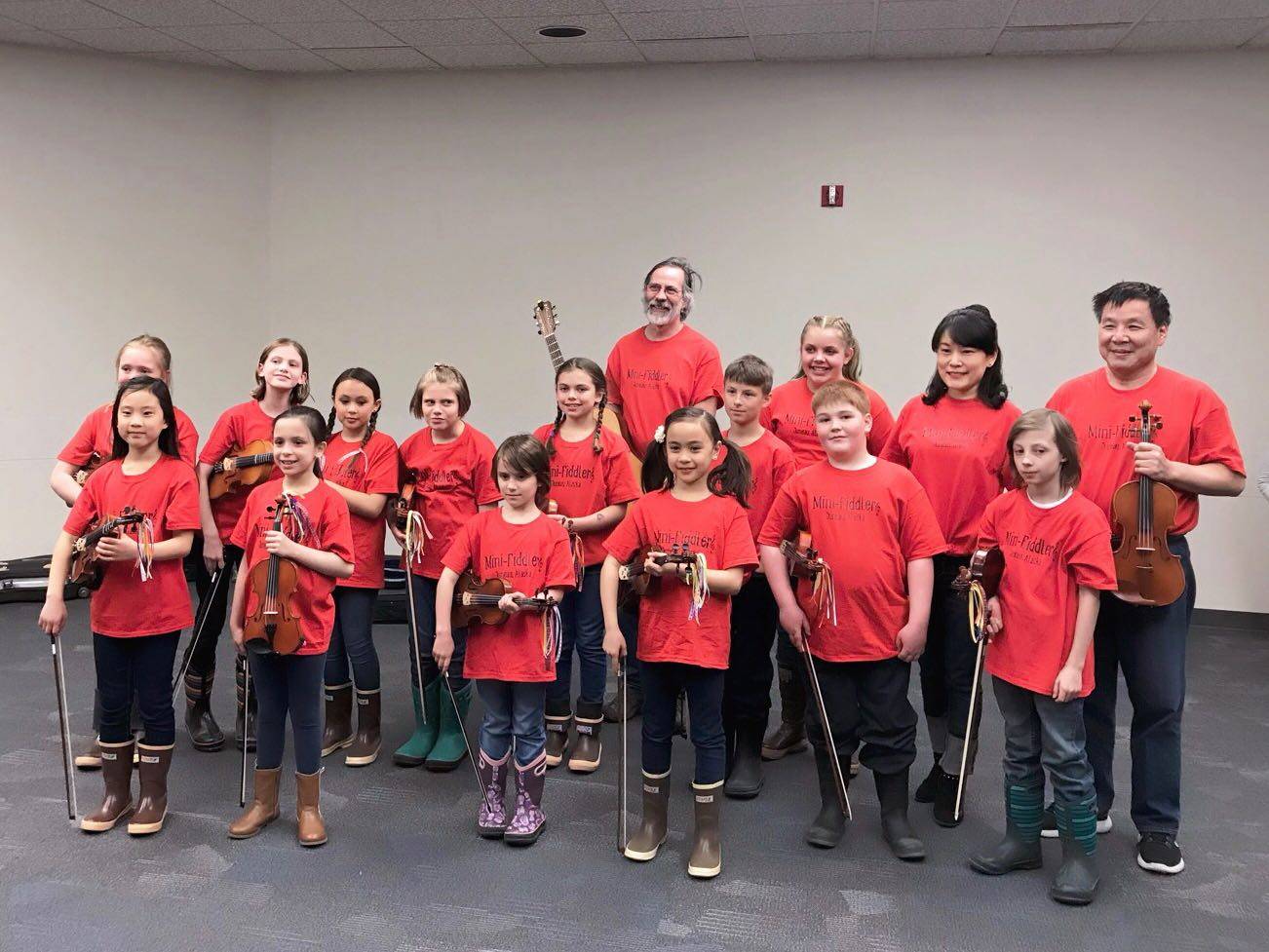 Mini-Fiddlers ready to perform at Folk Fest with accompanists Riley, Ali and Mei standing in the back row. Photo Courtesy of Xia.