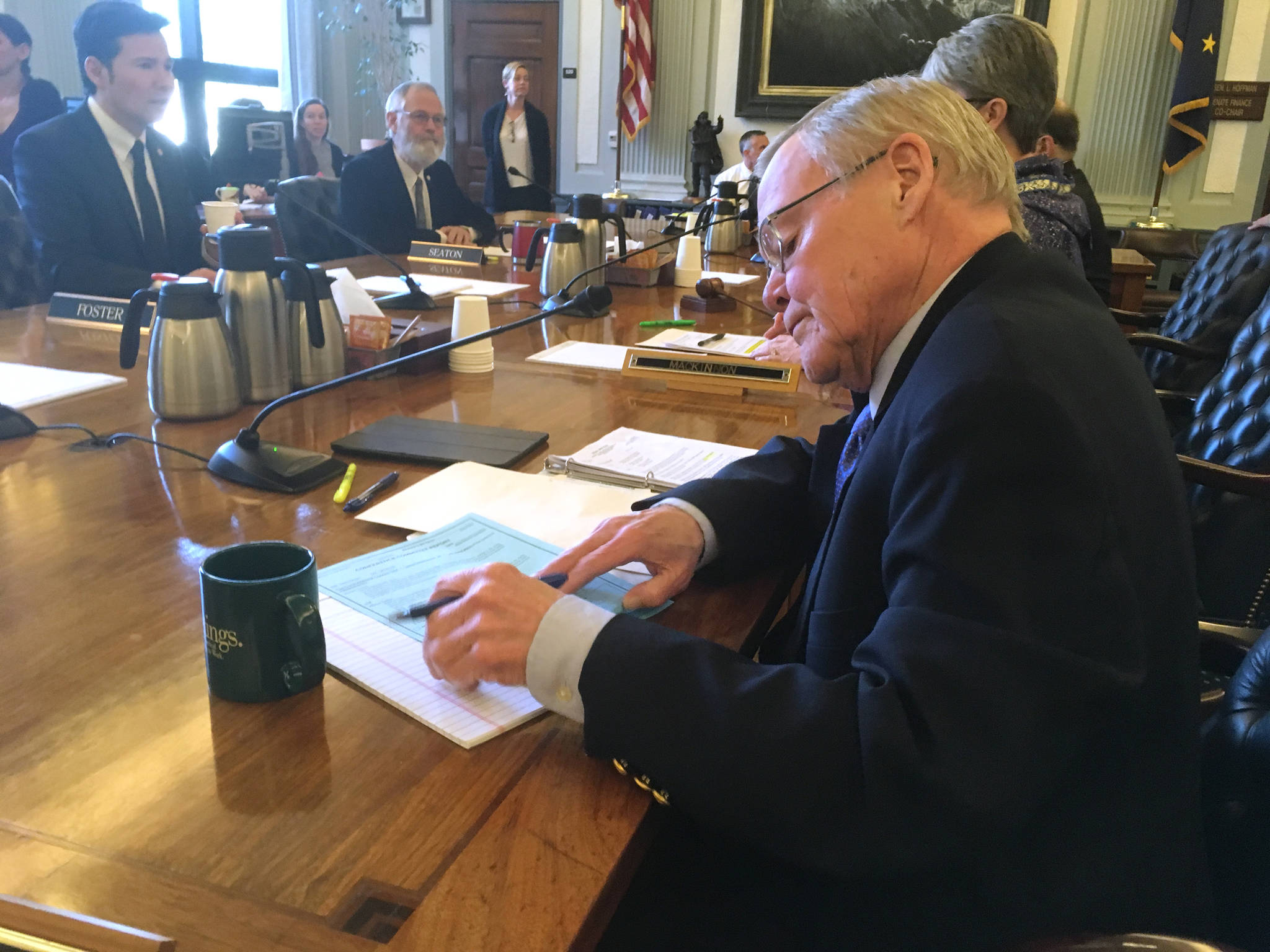 Sen. Dennis Egan, D-Juneau, signs the conference committee report on Senate Bill 26 on Tuesday, May 8, 2018. (James Brooks | Juneau Empire)