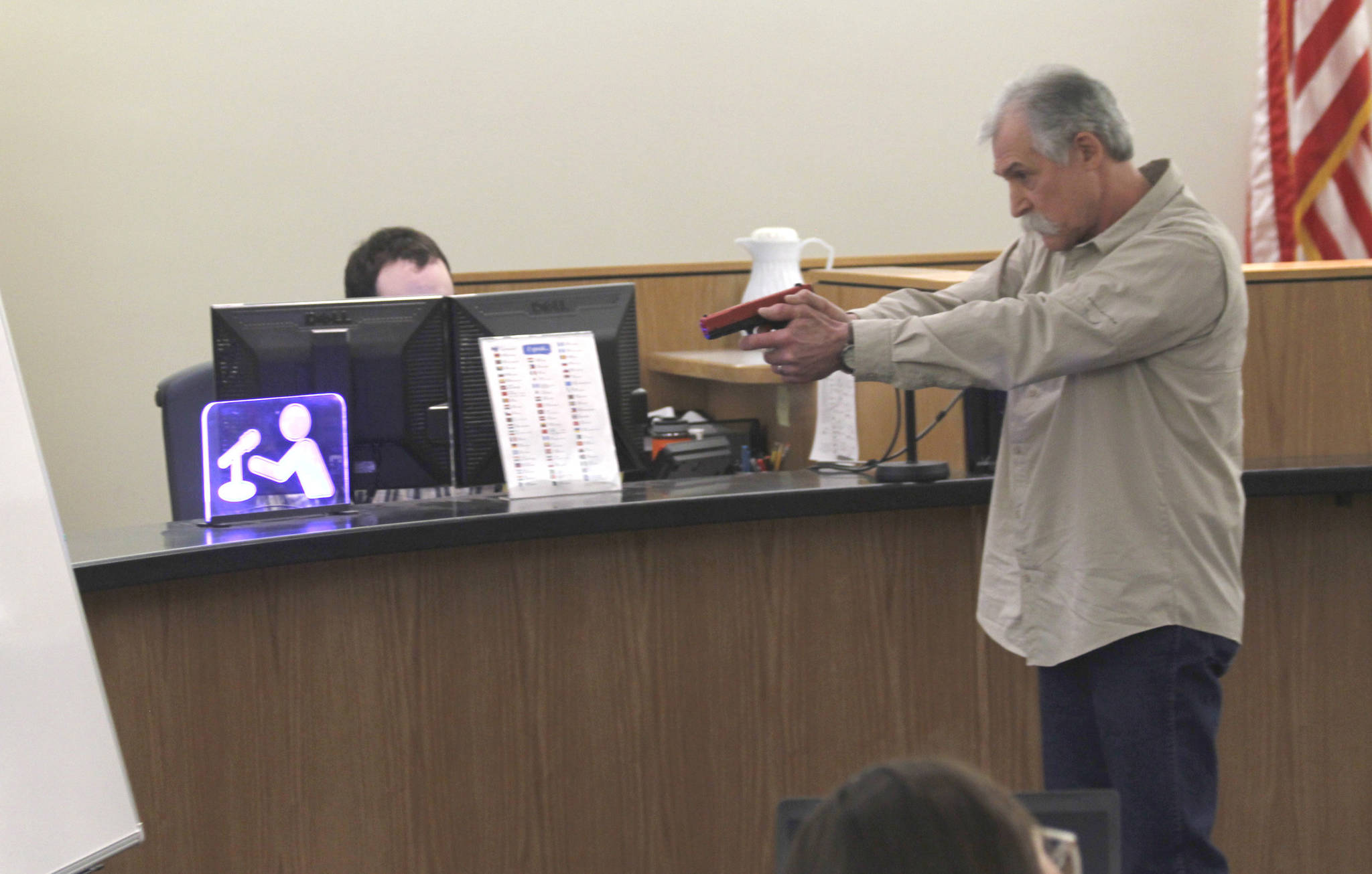 Chad Kendrick, firearm instructor and owner of Taku Tactical in Juneau, performs a firearm demonstration for members of the jury in the murder trial of Mark De Simone on May 8, 2018. De Simone is accused of killing Duilio Antonio “Tony” Rosales during a hunting trip in Excursion Inlet in 2016. (Alex McCarthy | Juneau Empire)