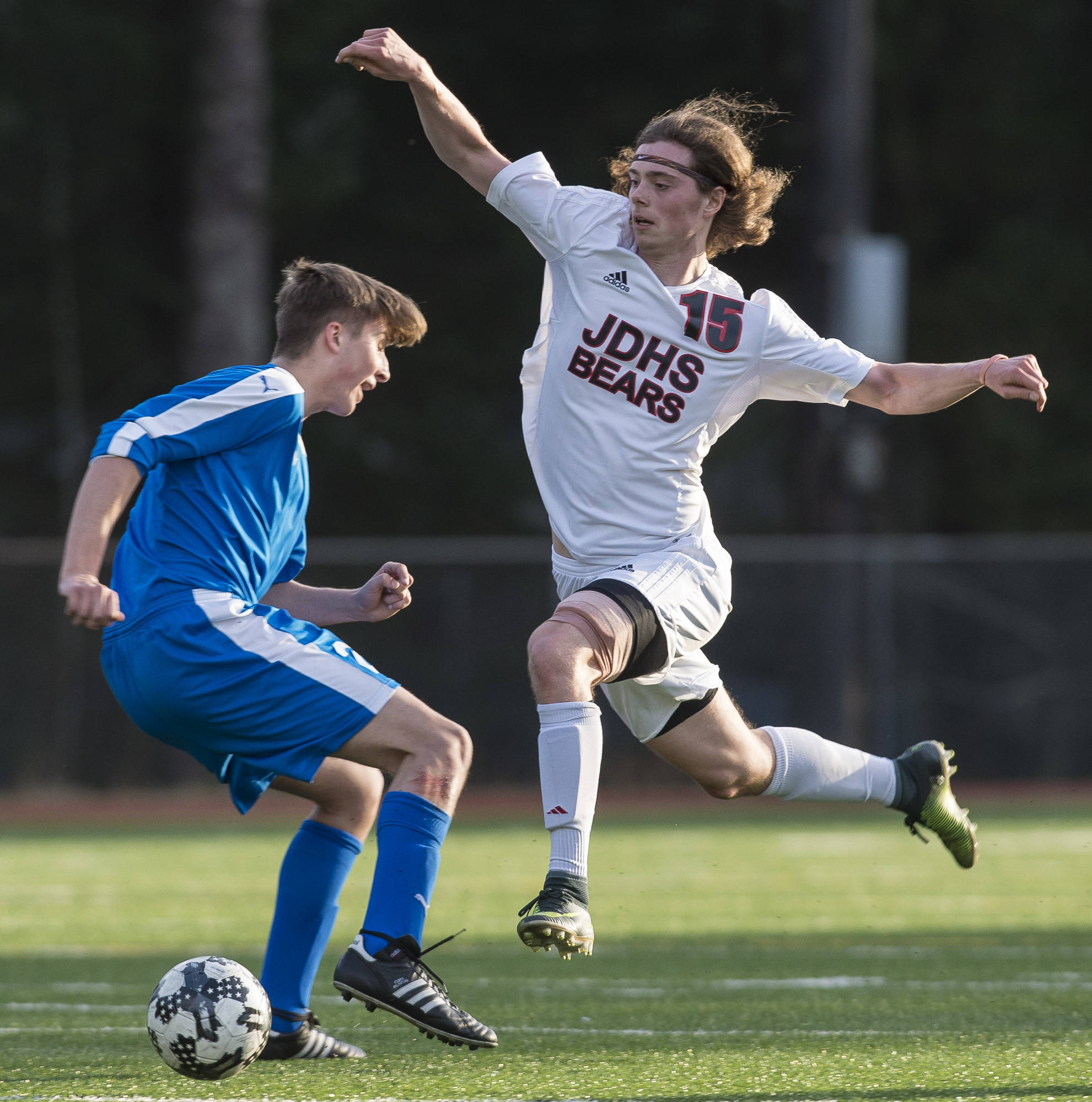 Juneau-Douglas’ Brysen Mitchell evades Thunder Mountain’sKieran Kollar as he drives down field at Adair-Kennedy Memorial Park on Tuesday, May 8, 2018. The game ended in a 2-2 tie. (Michael Penn | Juneau Empire)