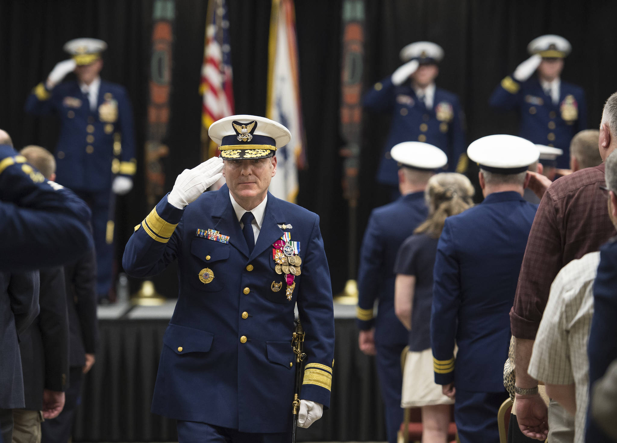 Rear Admiral Michael F. McAllister, outgoing Commander of the Coast Guard 17th District, leaves the stage during a Change of Command Ceremony for the U.S. Coast Guard 17th District at the Elizabeth Peratrovich Hall on Wednesday, May 9, 2018. (Michael Penn | Juneau Empire)