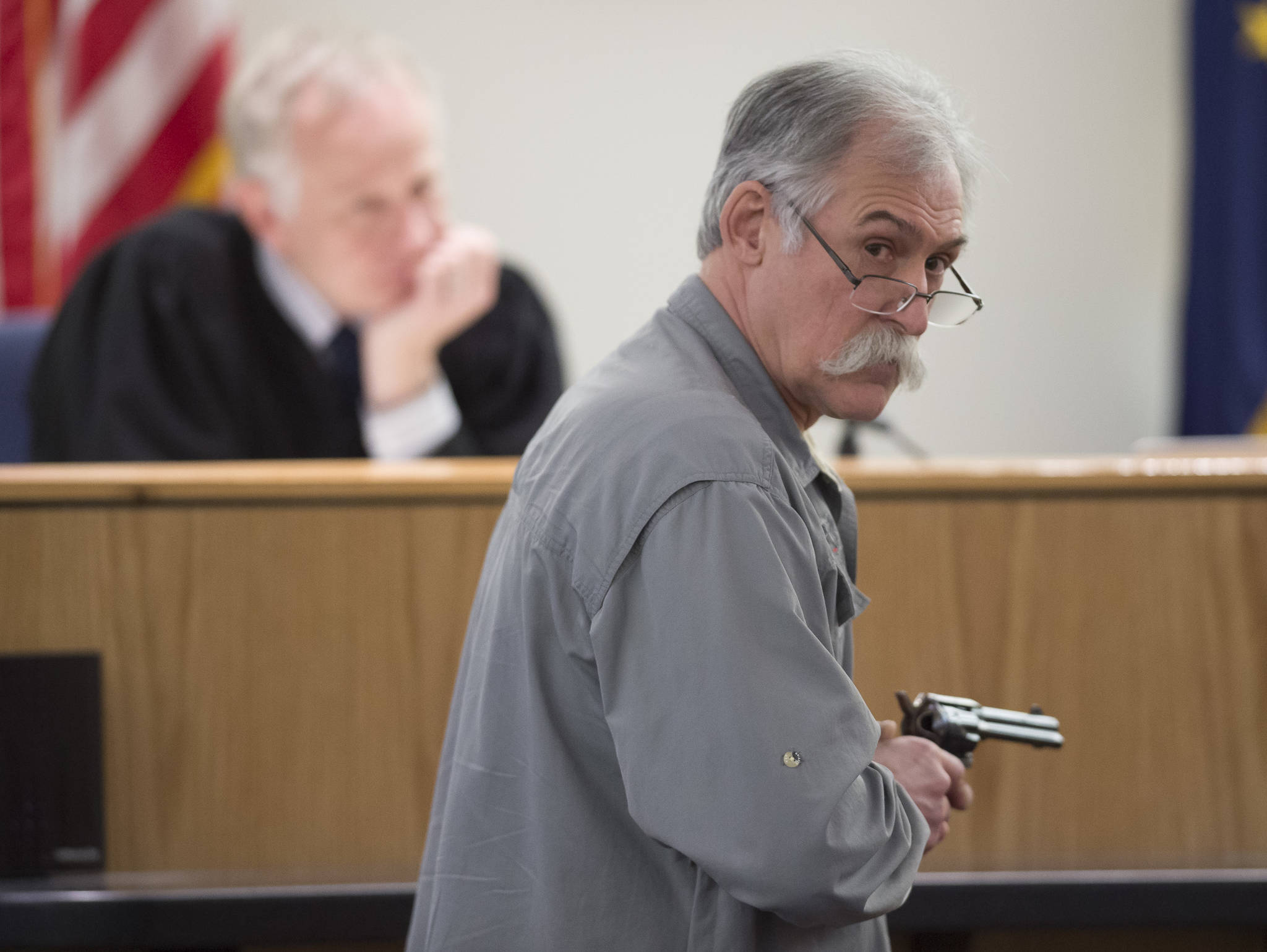 Chad Kendrick, a local firearms instructor and owner of Juneau gun and ammunition store Taku Tactical, is watched by Judge Philip Pallenberg during the trial of Mark De Simone in Juneau Superior Court on Wednesday, May 9, 2018. De Simone is accused of killing Duilio Antonio “Tony” Rosales during a hunting trip in Excursion Inlet in 2016. (Michael Penn | Juneau Empire)