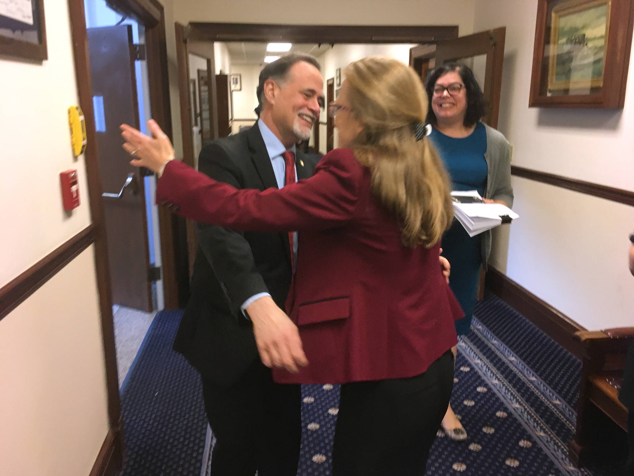 Sen. Peter Micciche, R-Soldotna (left), receives a hug from Emily Nenon, Alaska government relations director for the American Cancer Society Cancer Action Network. The action network was a major supporter of Senate Bill 63, and the pair were celebrating the passage of SB 63 on Saturday, May 12, 2018. (James Brooks | Juneau Empire)