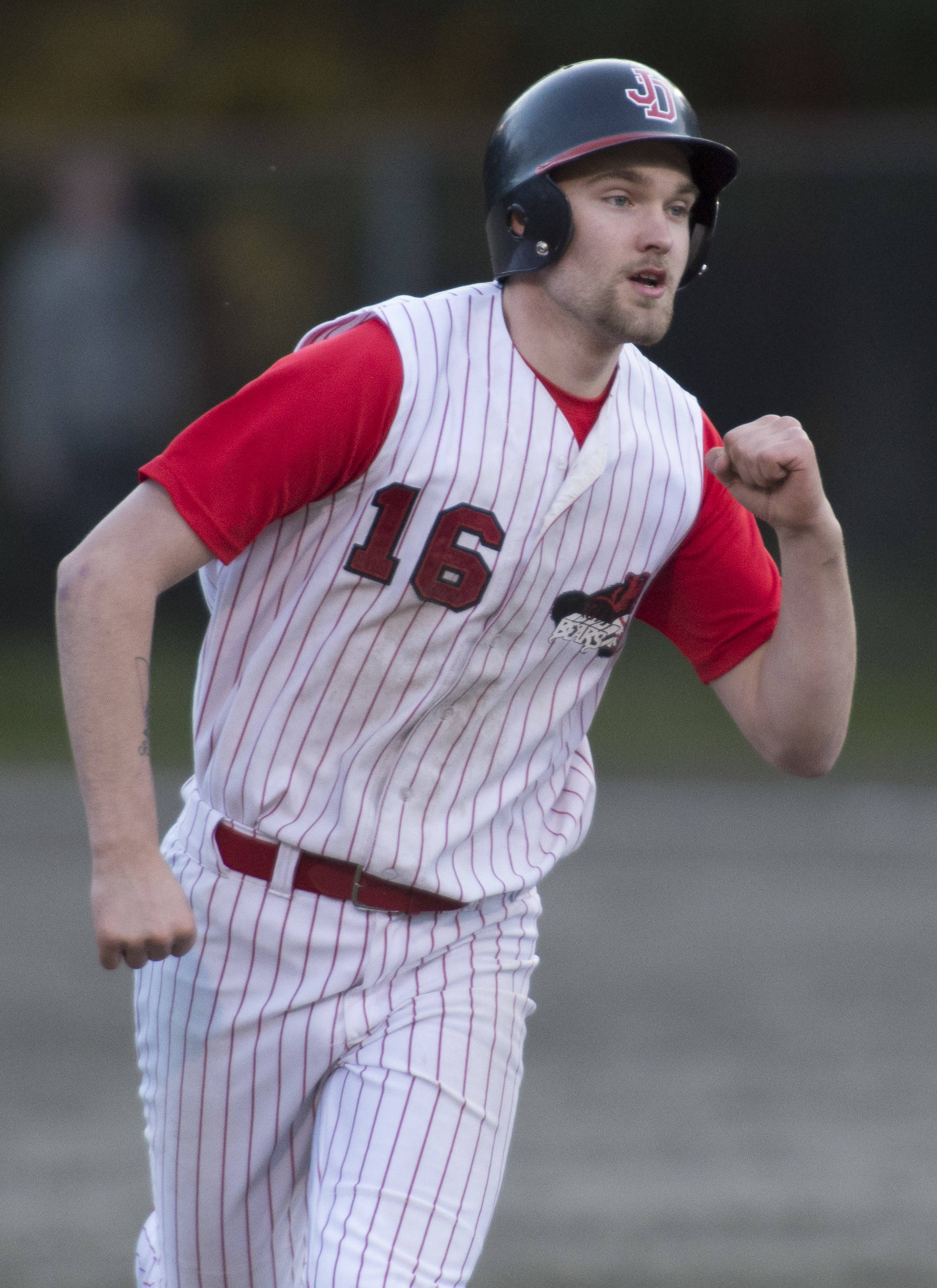 Juneau-Douglas’ Kasey Watts pumps his fist as he rounds the bases after hitting a home run against Thunder Mountain at Adair-Kennedy Memorial Park on Tuesday, May 15, 2018. (Michael Penn | Juneau Empire)