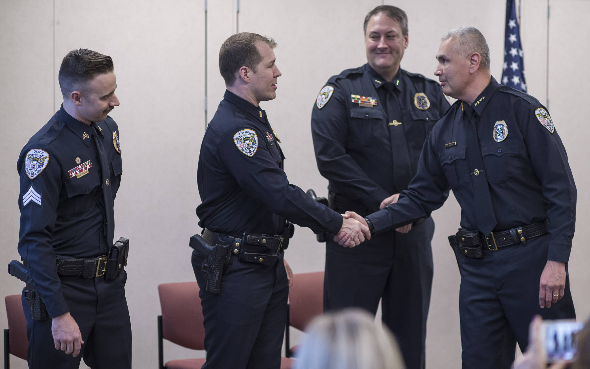 Juneau Police Department Chief Ed Mercer, right, congratulates Deputy Chief David Campbell, second from right, Lt. Krag Campbell, and Sgt. Ben Beck, left, during a promotions ceremony at the police station on Monday, Oct. 30, 2017. (Michael Penn | Juneau Empire File)