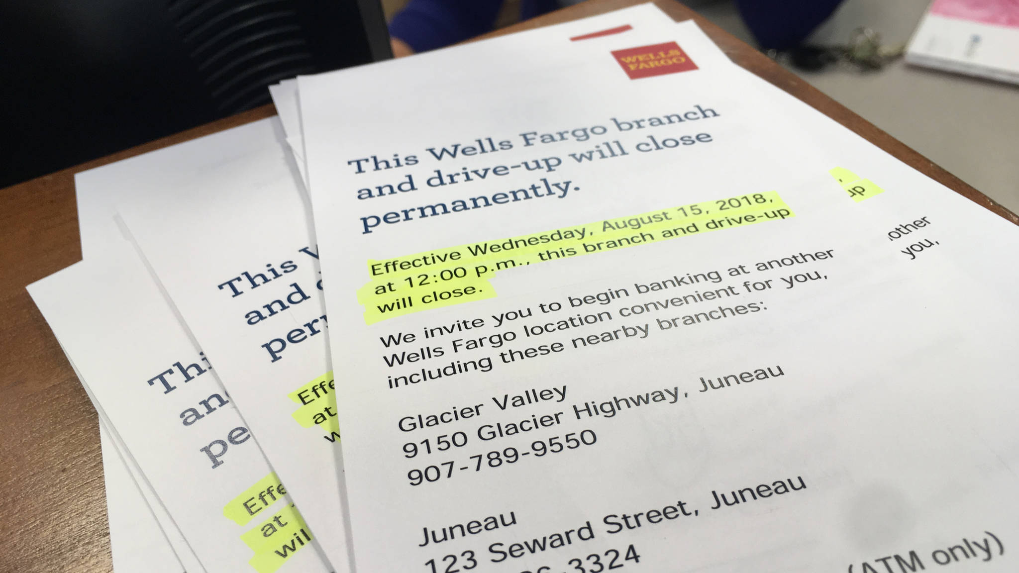 A stack of pamphlets explains the pending closure of the Lemon Creek branch of Wells Fargo bank on May 23, 2018. (James Brooks | Juneau Empire)