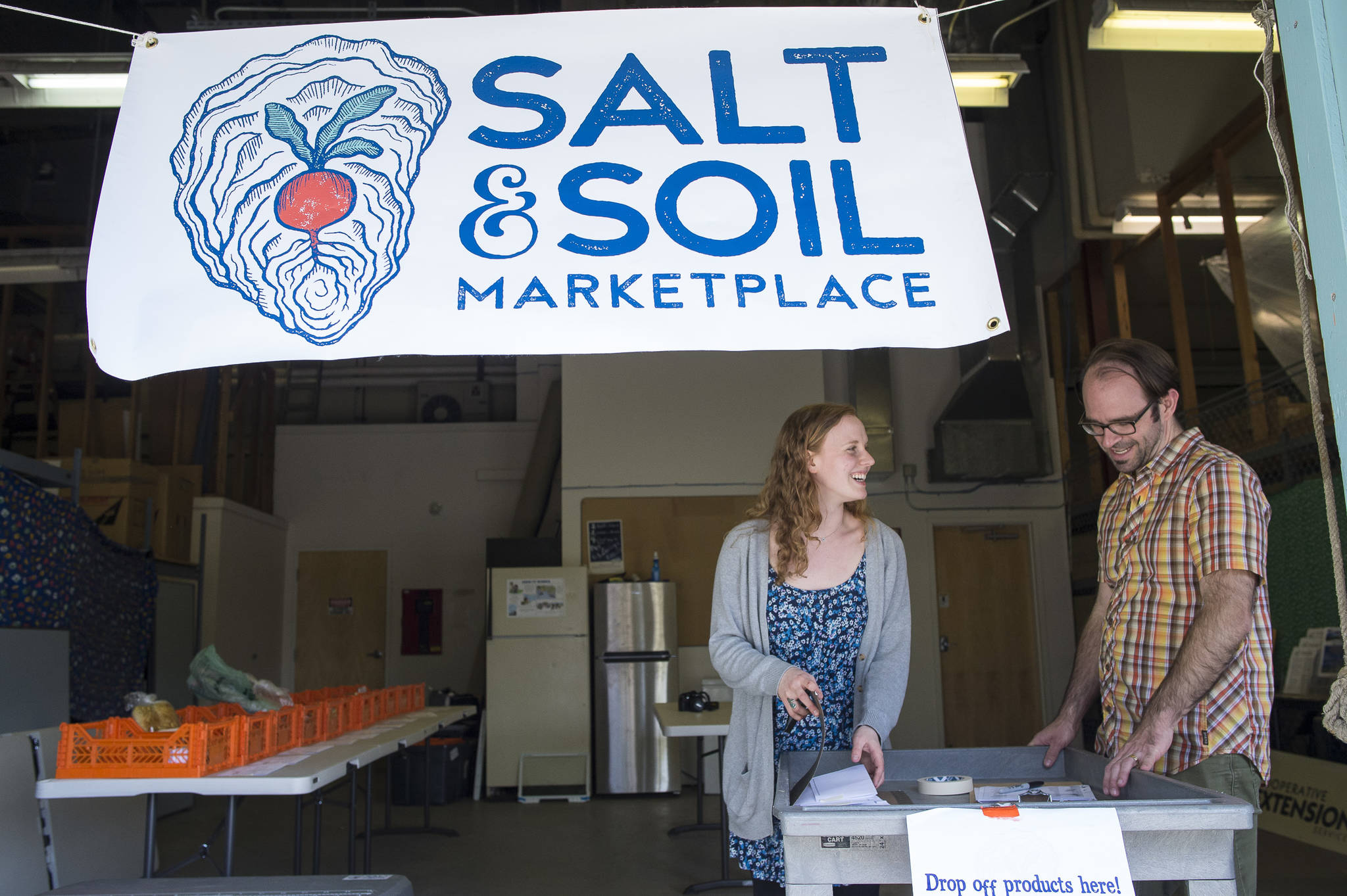 Lea Skaggs and Colin Peacock ready orders at their Salt & Soil Marketplace on Thursday, May 17, 2018. (Michael Penn | Juneau Empire)