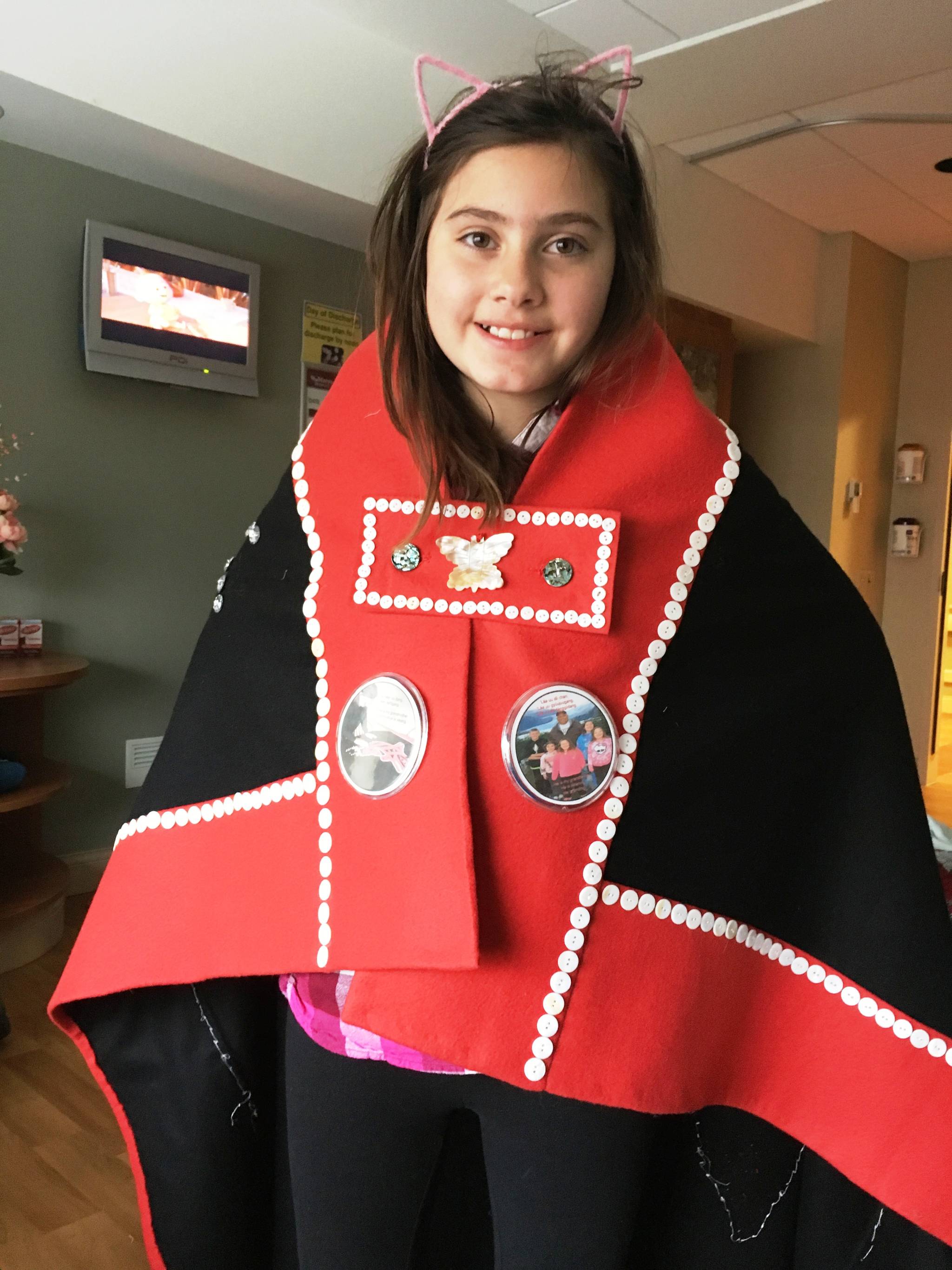 Leah Nelson shows off her button blanket. Courtesy image.