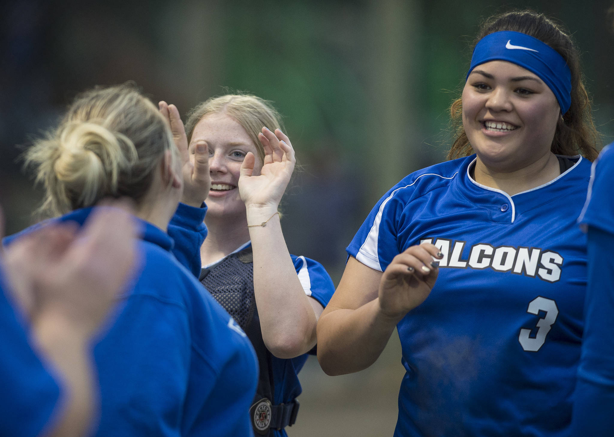 Thunder Mountain’s Nina Fenumiai, right, and Rachel Macaulay receive high-fives from Coach Brittany Gladsjo after beating Juneau-Douglas at Melvin Park earlier this month. Thunder Mountain plays Kodiak and North Pole in the state tournament today in Fairbanks. (Michael Penn | Juneau Empire File)