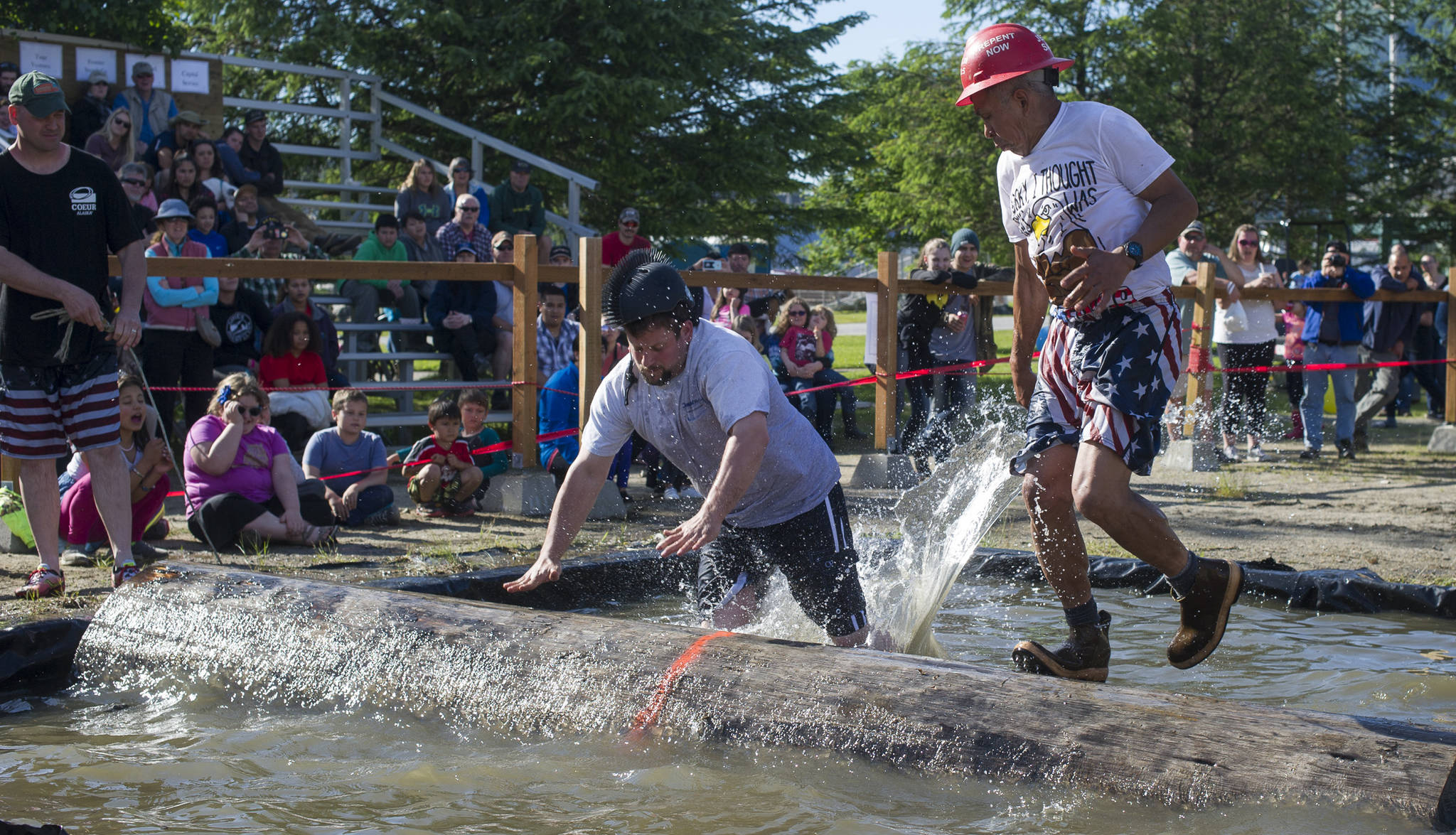 Ryan Friend, left, loses to Ralph “Animal” Austin during the log rolling contest at the 27th Annual Gold Rush Days Competition at Savikko Park on Sunday, June 18, 2017. (Michael Penn | Juneau Empire File)