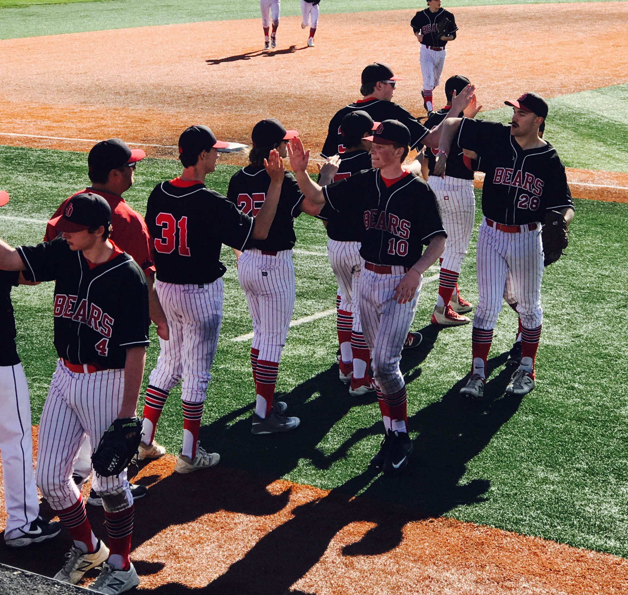 The Juneau-Douglas High School baseball team celebrates its 10-6 win over Colony High School in the ASAA state baseball championships on Friday night at Mulcahy Stadium in Anchorage. (Courtesy Photo | Tami Wahto)