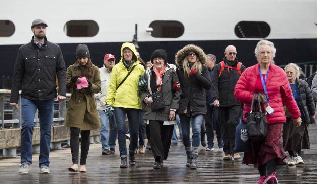 Passengers walk off Holland America Line’s Nieuw Amsterdam on Monday, May 1, 2017. (Michael Penn | Juneau Empire File)