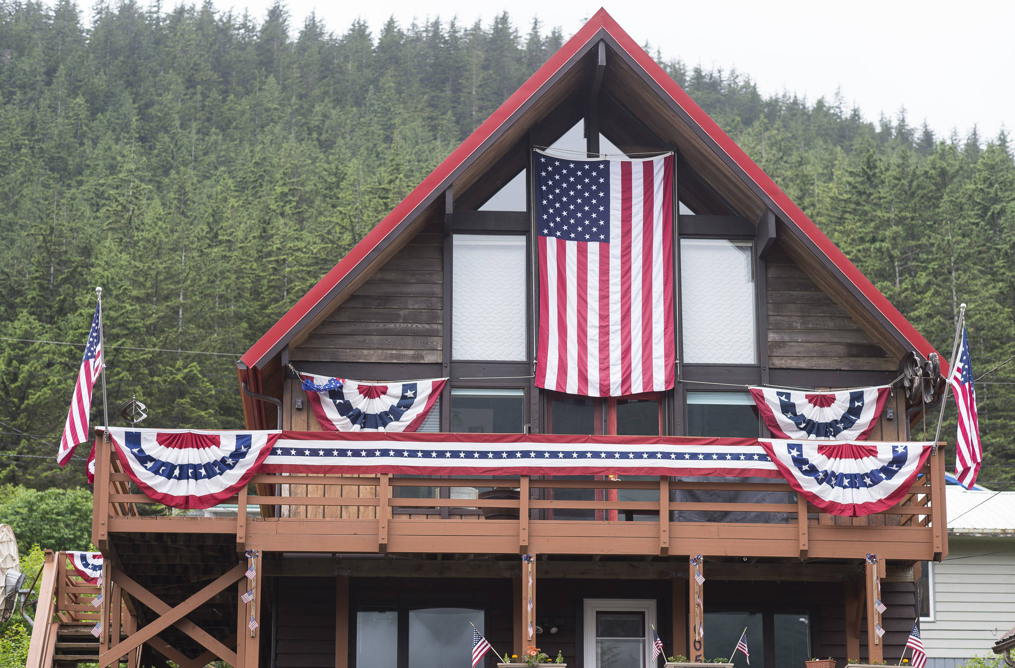 A house at 605 St. Ann’s Street places second in the House decorations as Capital City Fire/Rescue Volunteer Firefighters Antonia Elstad and Meg Thordarson tour Douglas properties to judge on Flag Day, Thursday, June 14, 2018. (Michael Penn | Juneau Empire)