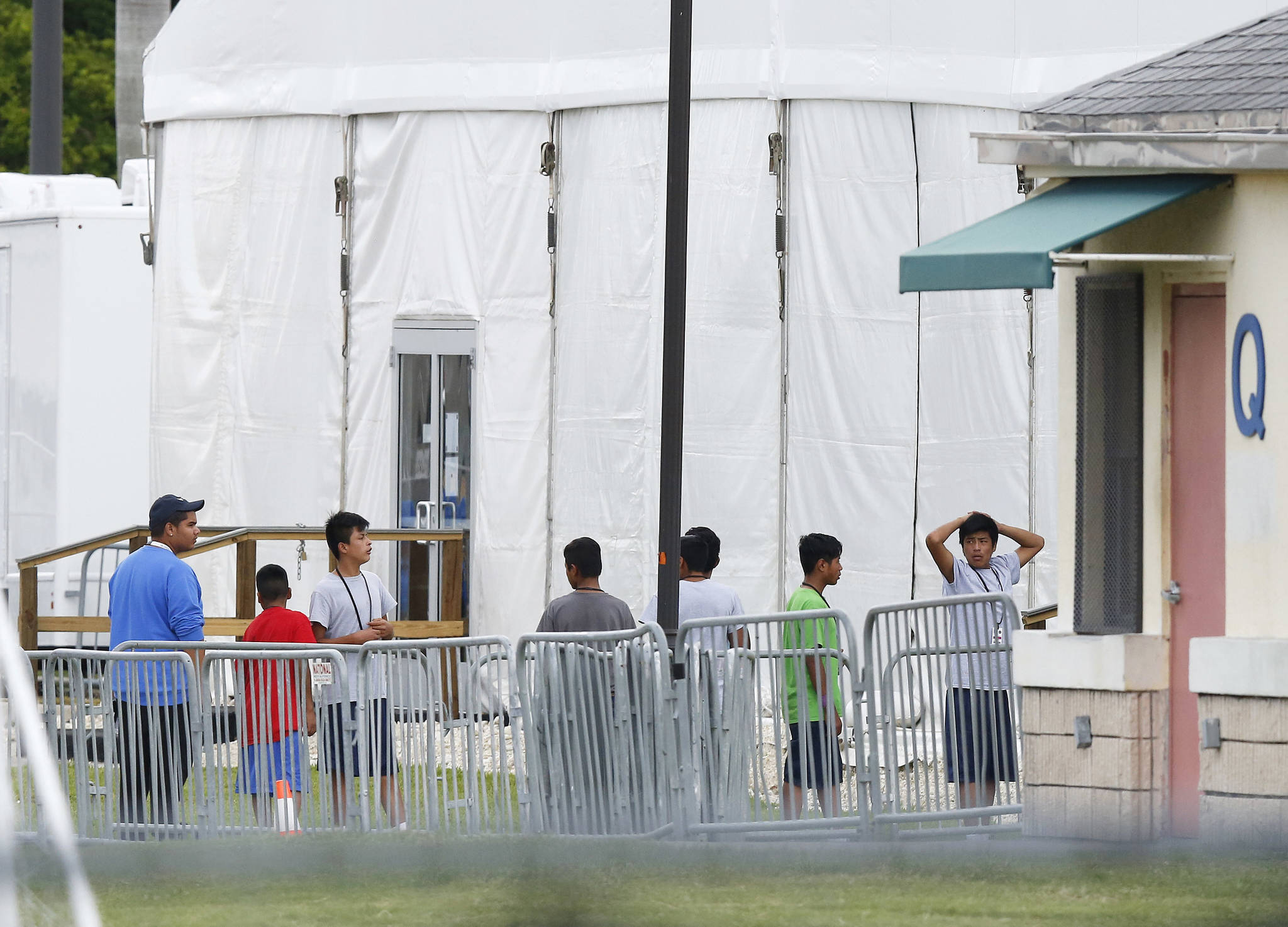 Immigrant children walk in a line outside the Homestead Temporary Shelter for Unaccompanied Children, a former Job Corps site that now houses them, on Wednesday, June 20, 2018, in Homestead, Florida. U.S. Rep. Carlos Curbelo said he found it “troubling” to see two of his Democratic colleagues turned away from the Miami-area detention center for migrant children. (Brynn Anderson | The Associated Press)