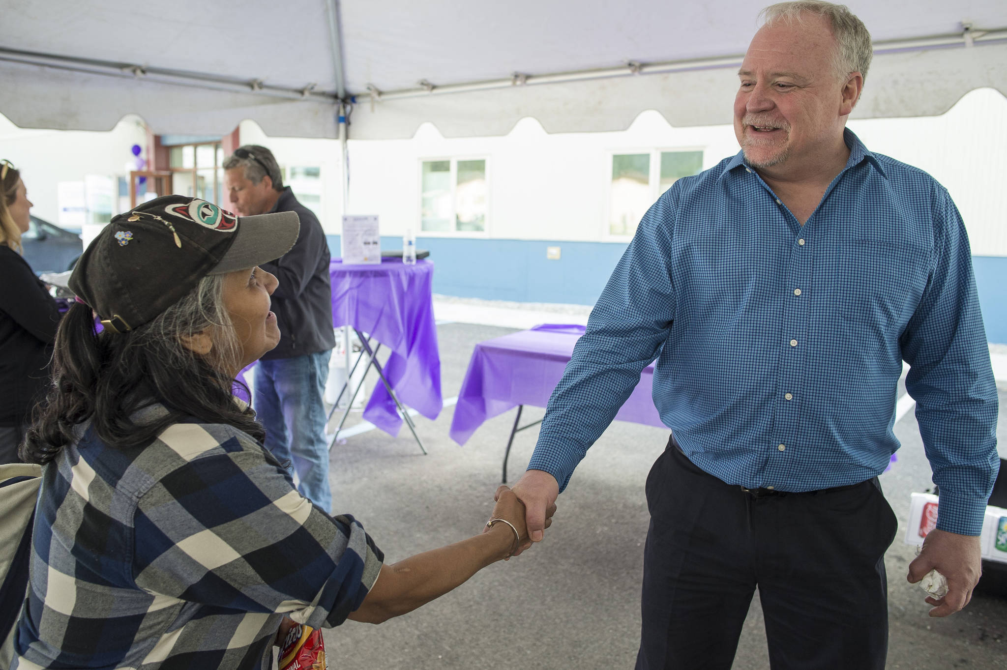 Dave Branding, CEO of JAMHI Health & Wellness, Inc., greets Angelina Lundy during an open house at JAMHI’s Midtown Clinic located at the House First Project on Friday, June 22, 2018. (Michael Penn | Juneau Empire)