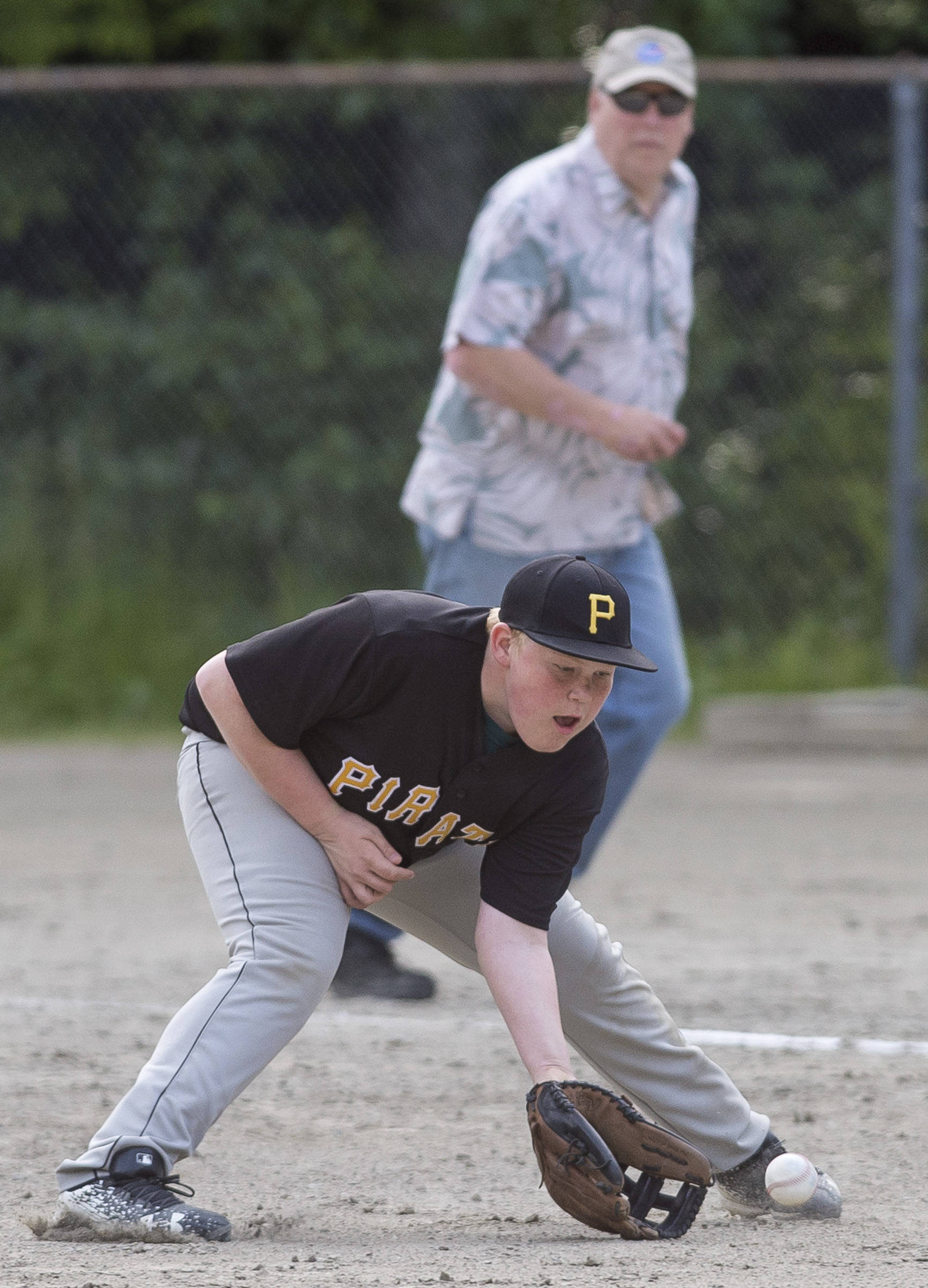 Pirates’ first baseman Mason Ackman fields a Red Sox infield hit at the Gastineau Channel Little League Junior Division Championship game at Adair-Kennedy Memorial Park on Friday. (Michael Penn | Juneau Empire)