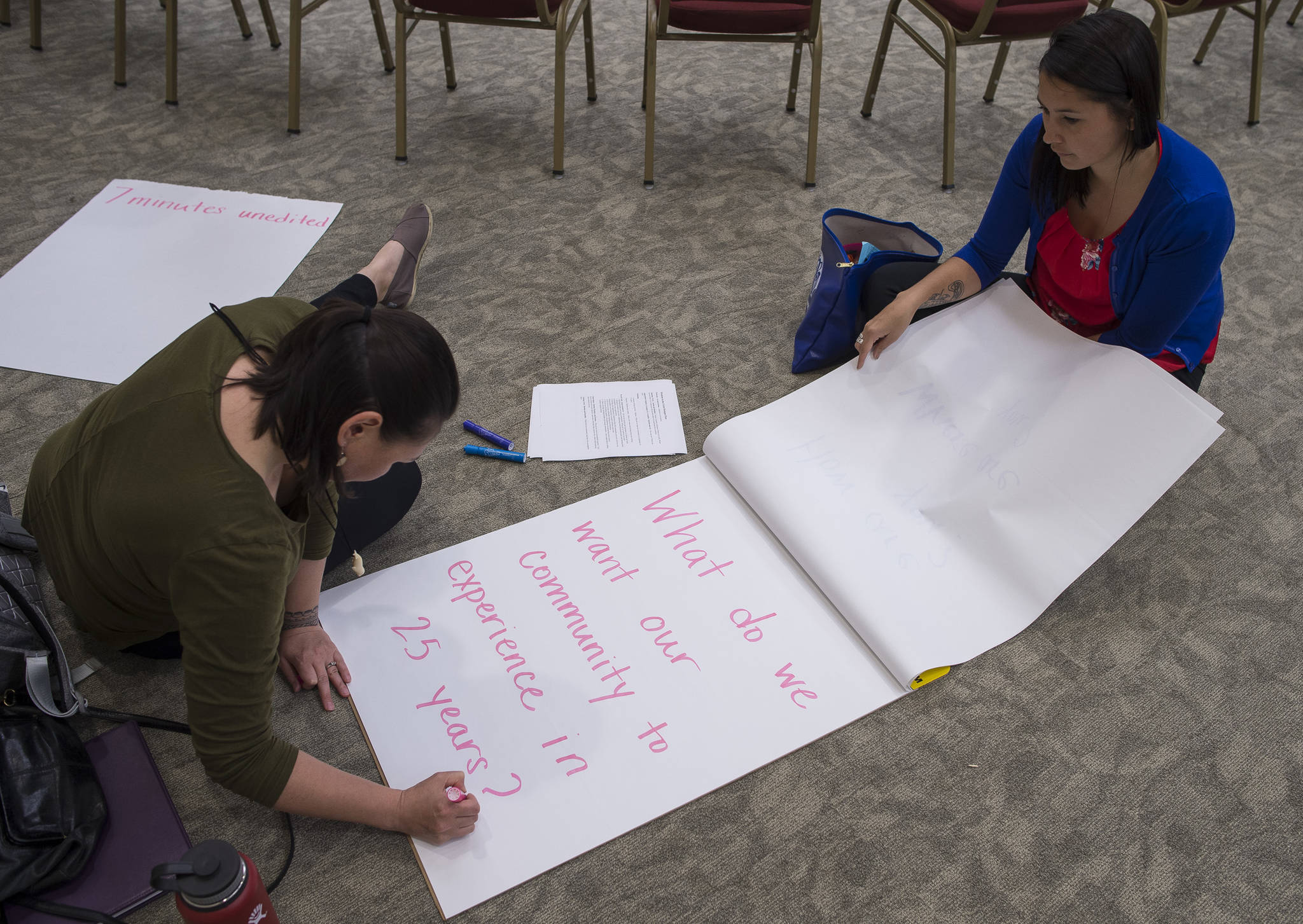 Darlene Trigg and Heather Gatti write out questions before the Wisdom in the Circle meeting at Elizabeth Peratrovich Hall on Monday, June 25, 2018. The event is hosted by Tlingit & Haida, AWARE, and the Juneau Violence Prevention Coalition. (Michael Penn | Juneau Empire)