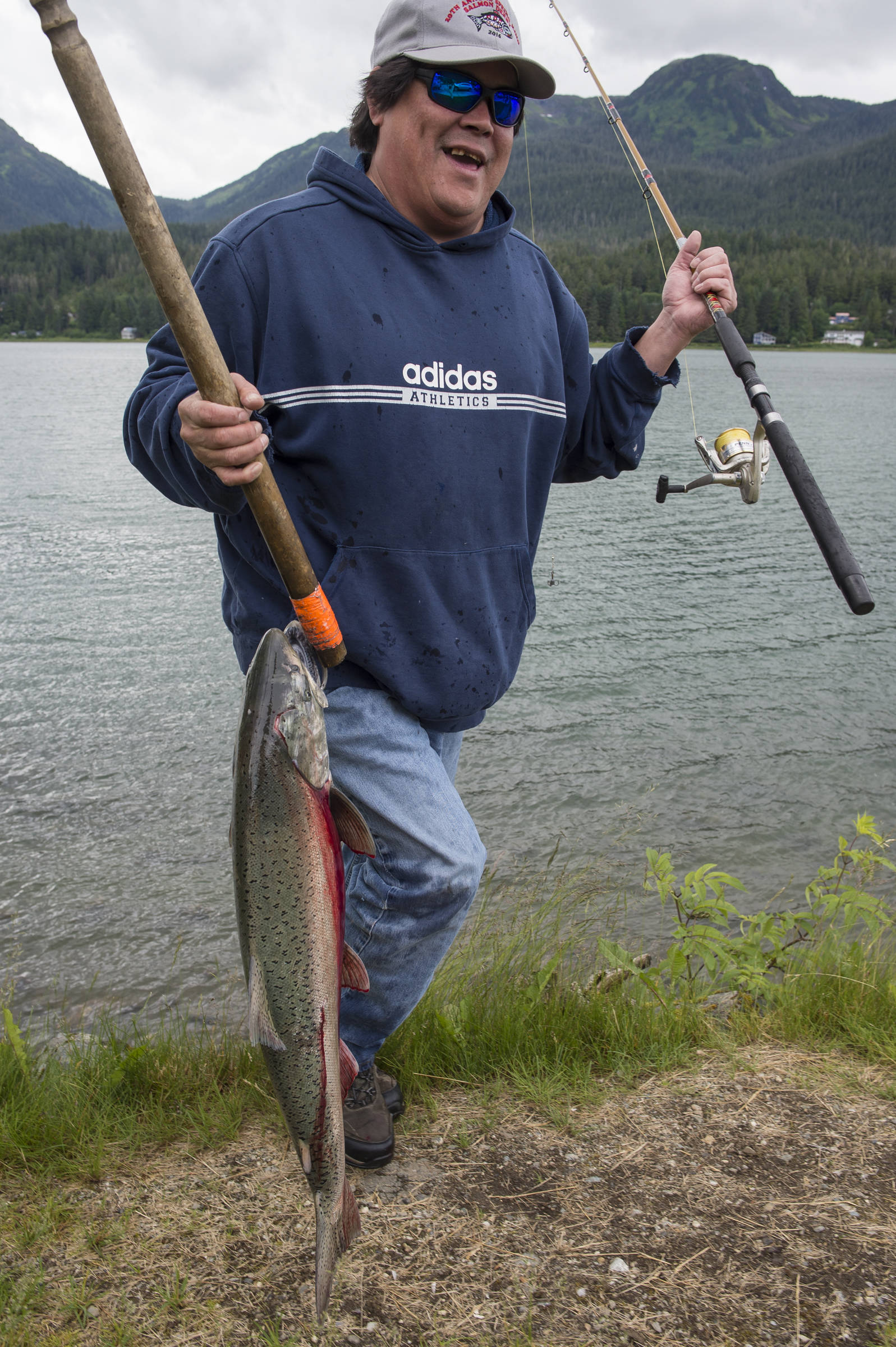 Nick Vonda brings up a king salmon he caught at the Wayside Park on Channel Drive on Tuesday, June 26, 2018. Beginning at 12:01 a.m. Sunday, July 1st, sport fishing for king salmon and snagging will be prohibited from the shoreline to 200 yards offshore between the end of Channel Drive and a point near the Samson Tug and Barge property to ensure that enough king salmon make it up the fish ladder to meet egg-take goals needed for future production. (Michael Penn | Juneau Empire)