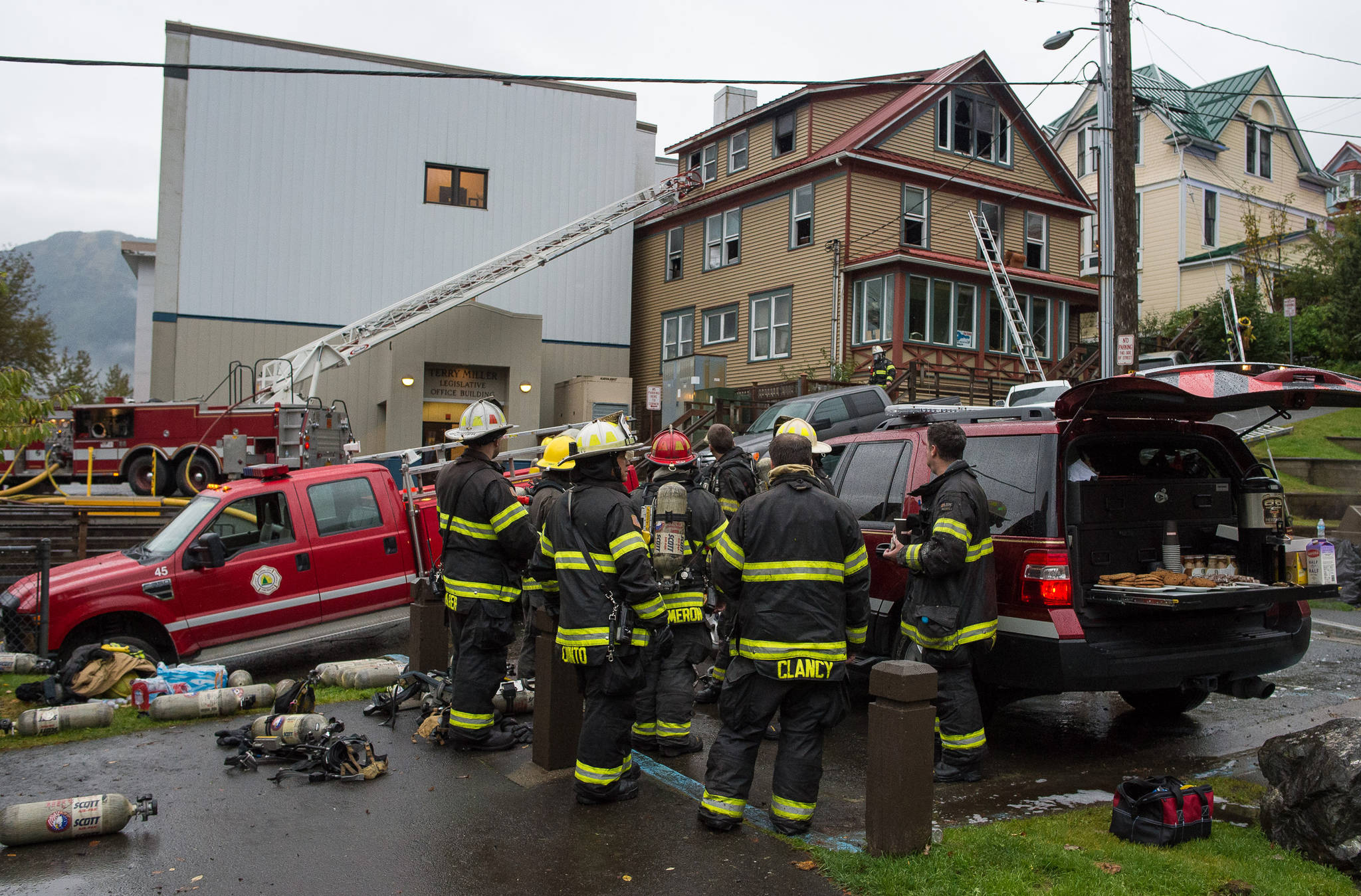 In this Sept. 17, 2017 photo, Capital City Fire/Rescue cleans up after fighting a fire at 526 Seward Street, next to the Terry Miller Legislative Building. (Michael Penn | Juneau Empire File)