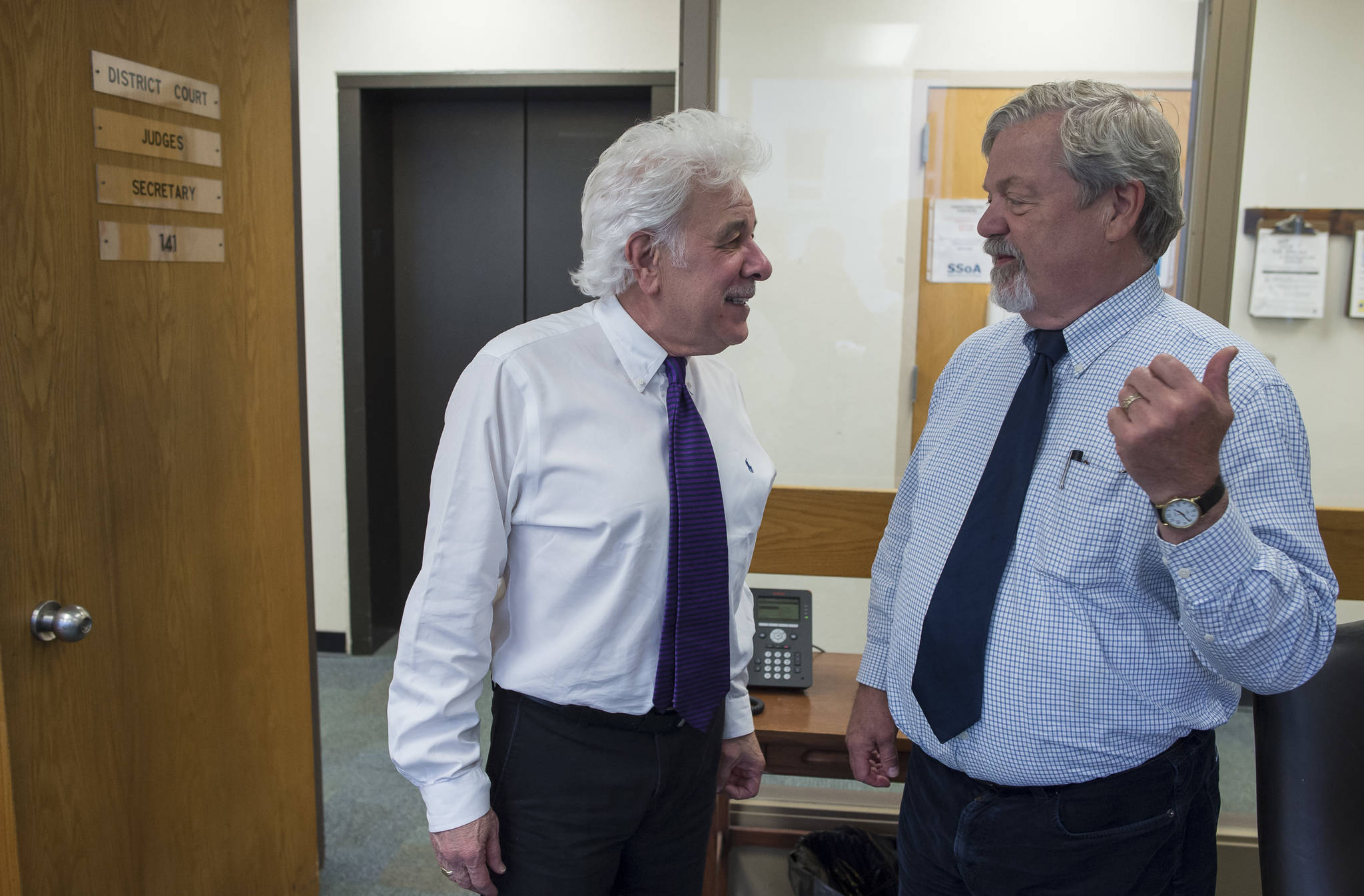 Juneau Superior Court Judge Louis Menendez, left, and Juneau District Court Judge Thomas Nave talk with each other outside their individual offices at the Dimond Courthouse on Friday, June 29, 2018. Both judges are retiring and Friday was their last day at work. Speaking about Judge Nave Judge Menendez said, “He is my best friend. I would do anything for him.”