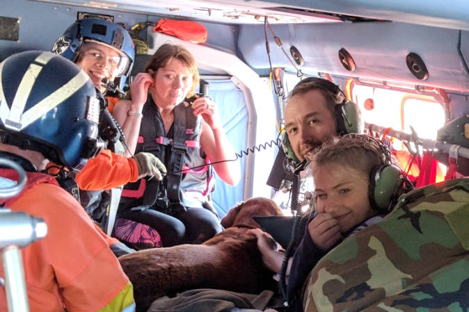 A 13-year-old girl and her aunt and uncle are taken back to a cabin on Kruzof Island, Alaska, July 3, 2018, in an Air Station Sitka MH-60 Jayhawk helicopter. The girl was reported missing in a kayak in Shelikof Bay, last seen wearing a purple, blue and black life jacket, and was later found by the Jayhawk crew in good condition. (U.S. Coast Guard | Courtesy Photo)