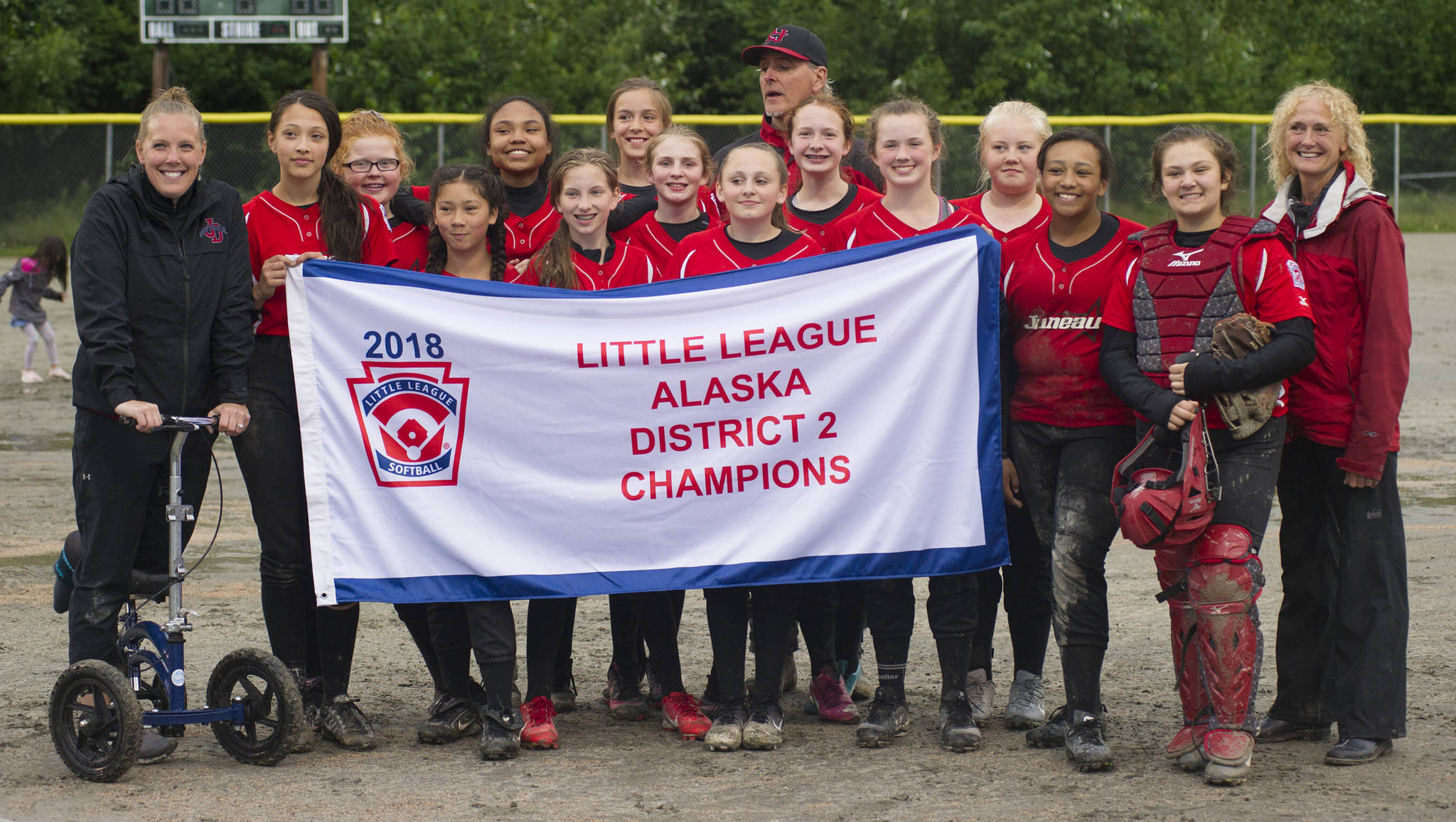 The GCLL Major Softball All-Stars pose with their Alaska District 2 championship banner after defeating Ketchikan Little League, 6-3, in the championship game. (Nolin Ainsworth | Juneau Empire)