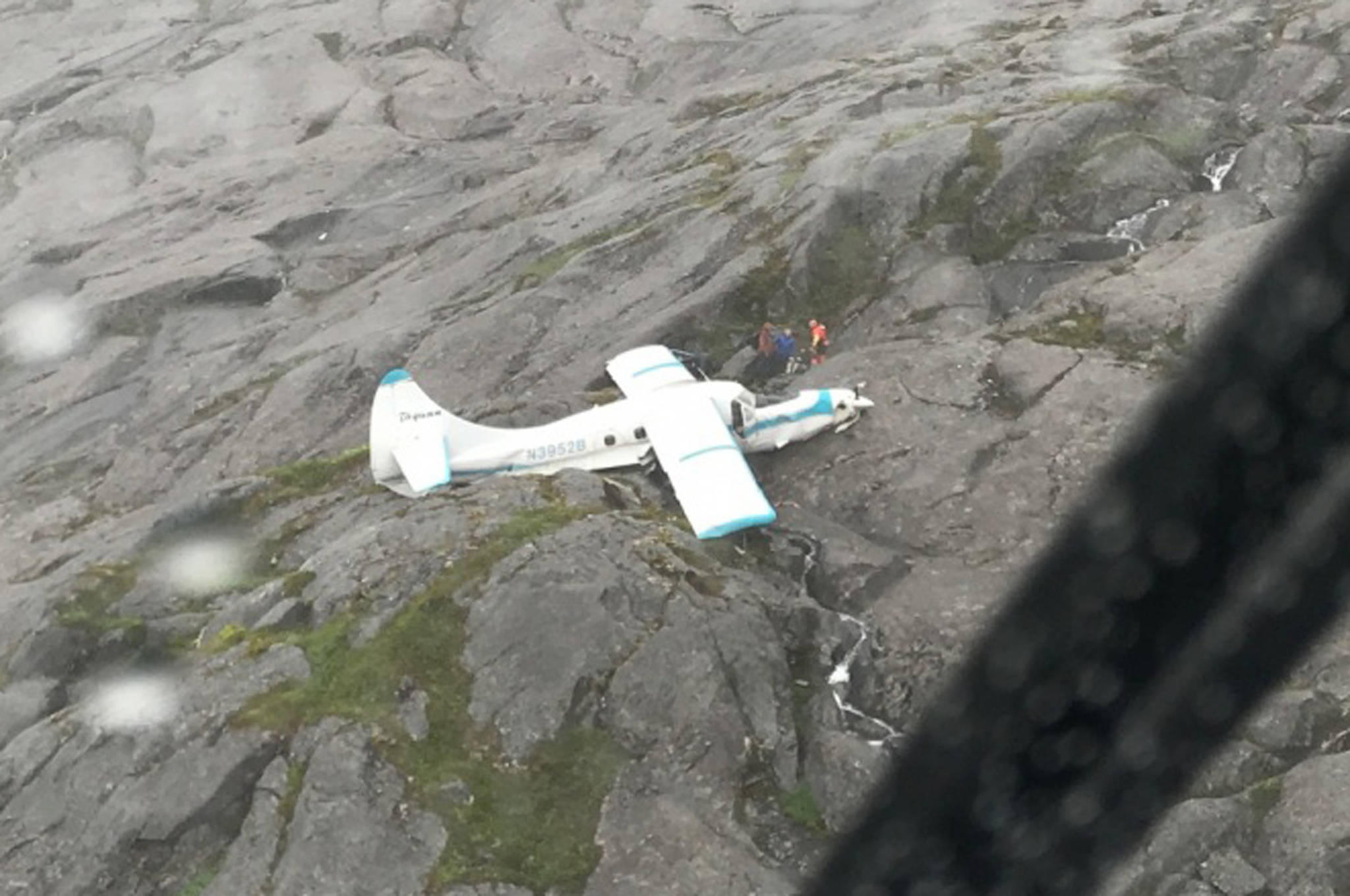Two Coast Guard Air Station Sitka MH-60 Jayhawk helicopter crews rescue 11 people after a float plane crashed 39 miles south southwest of Ketchikan, Alaska, on Prince of Wales Island, July 10, 2018. All 11 people were taken to a staging area nearby for further transfer to Ketchikan. (U.S. Coast Guard | Courtesy Photo)