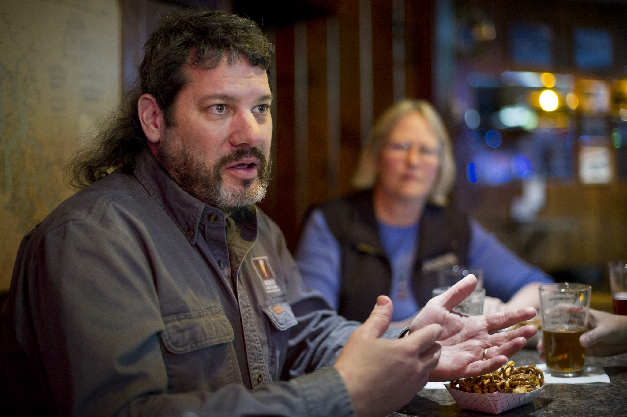 Paul Gatza, director of the trade and advocacy group for craft beer brewers in the United States called Brewers Association, talks about the industry during a stop at the Triangle Bar in Juneau on Wednesday. (Michael Penn | Juneau Empire)