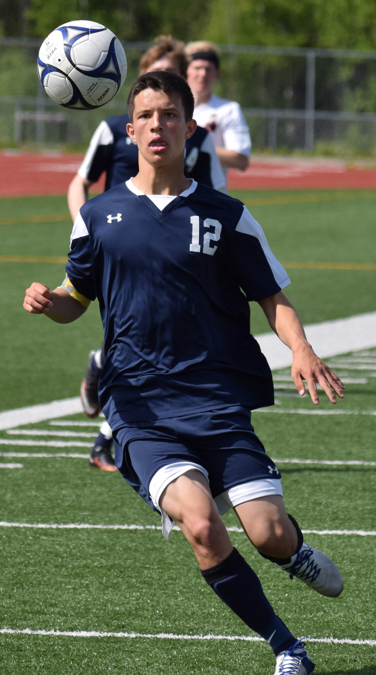 Soldotna senior Dylan Kuntz keeps an eye on the ball Friday afternoon at Eagle River High School in a state soccer semifinal against Juneau-Douglas. JDHS won 4-2.