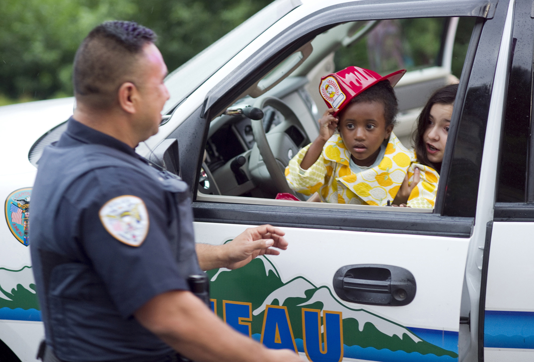 Elle Yerkes, 5, center, and Sydney Truitt, 11, try out the front seat of Officer Elias Joven's patrol vehicle during a National Night Out block party in 2012. This year, police will participate in the nationwide community-building campaign on Aug. 2.